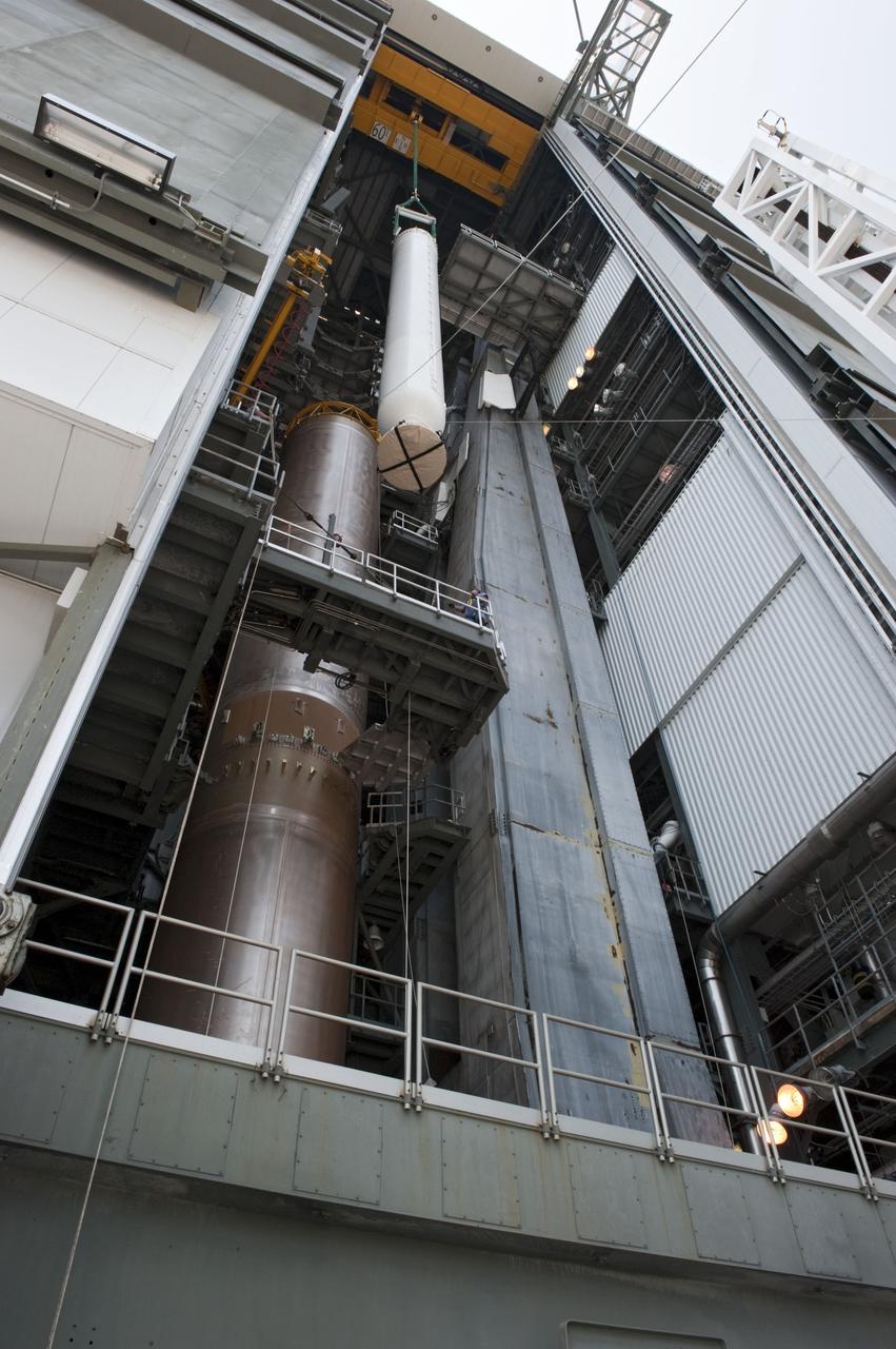 CAPE CANAVERAL, Fla. -- At Cape Canaveral Air Force Station in Florida, workers using an overhead crane lift a solid rocket motor into the Vertical Integration Facility at Launch Complex 41. It then will be attached to the United Launch Alliance Atlas V booster stage, already at the pad. NASA's Juno spacecraft is scheduled to launch aboard an Atlas V from Cape Canaveral, Fla. Aug. 5.The solar-powered spacecraft will orbit Jupiter's poles 33 times to find out more about the gas giant's origins, structure, atmosphere and magnetosphere and investigate the existence of a solid planetary core. For more information visit: www.nasa.gov/juno. Photo credit: NASA/Kim Shiflett