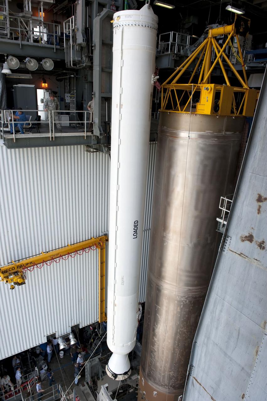CAPE CANAVERAL, Fla. -- At Cape Canaveral Air Force Station in Florida, workers using an overhead crane lift a solid rocket motor into the Vertical Integration Facility at Launch Complex 41. It then will be attached to the United Launch Alliance Atlas V booster stage, already at the pad. NASA's Juno spacecraft is scheduled to launch aboard an Atlas V from Cape Canaveral, Fla. Aug. 5.The solar-powered spacecraft will orbit Jupiter's poles 33 times to find out more about the gas giant's origins, structure, atmosphere and magnetosphere and investigate the existence of a solid planetary core. For more information visit: www.nasa.gov/juno. Photo credit: NASA/Kim Shiflett