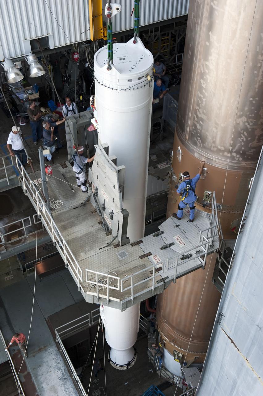CAPE CANAVERAL, Fla. -- At Cape Canaveral Air Force Station in Florida, workers using an overhead crane guide a solid rocket motor into position in the Vertical Integration Facility at Launch Complex 41. It then will be attached to the United Launch Alliance Atlas V booster stage, already at the pad. NASA's Juno spacecraft is scheduled to launch aboard an Atlas V from Cape Canaveral, Fla. Aug. 5.The solar-powered spacecraft will orbit Jupiter's poles 33 times to find out more about the gas giant's origins, structure, atmosphere and magnetosphere and investigate the existence of a solid planetary core. For more information visit: www.nasa.gov/juno. Photo credit: NASA/Kim Shiflett