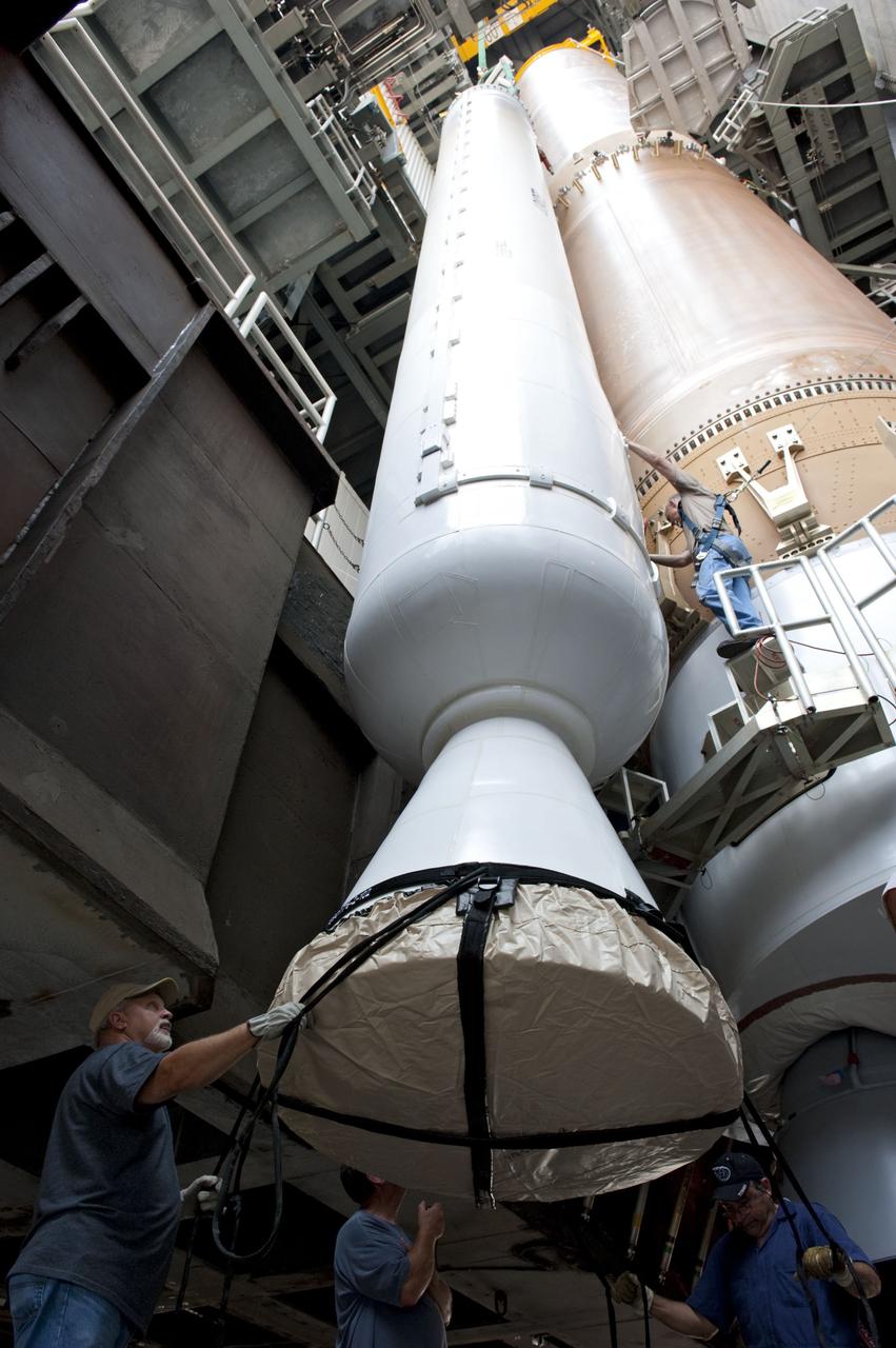 CAPE CANAVERAL, Fla. -- At Cape Canaveral Air Force Station in Florida, workers using an overhead crane guide a solid rocket motor into position in the Vertical Integration Facility at Launch Complex 41. It then will be attached to the United Launch Alliance Atlas V booster stage, already at the pad. NASA's Juno spacecraft is scheduled to launch aboard an Atlas V from Cape Canaveral, Fla. Aug. 5.The solar-powered spacecraft will orbit Jupiter's poles 33 times to find out more about the gas giant's origins, structure, atmosphere and magnetosphere and investigate the existence of a solid planetary core. For more information visit: www.nasa.gov/juno. Photo credit: NASA/Kim Shiflett