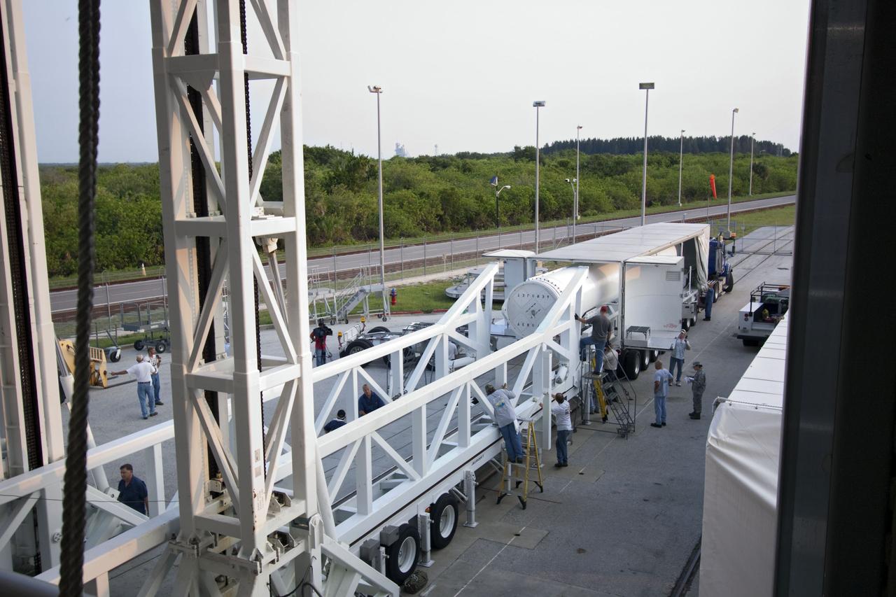 CAPE CANAVERAL, Fla. -- At Cape Canaveral Air Force Station in Florida, workers prepare the fifth and final solid rocket booster for lifting into the Vertical Integration Facility at Launch Complex 41. It then will be lifted into position and attached to the United Launch Alliance Atlas V booster stage, already at the pad.            NASA's Juno spacecraft is scheduled to launch aboard an Atlas V from Cape Canaveral, Fla. Aug. 5.The solar-powered spacecraft will orbit Jupiter's poles 33 times to find out more about the gas giant's origins, structure, atmosphere and magnetosphere and investigate the existence of a solid planetary core. For more information visit: www.nasa.gov/juno. Photo credit: NASA/Jim Grossmann
