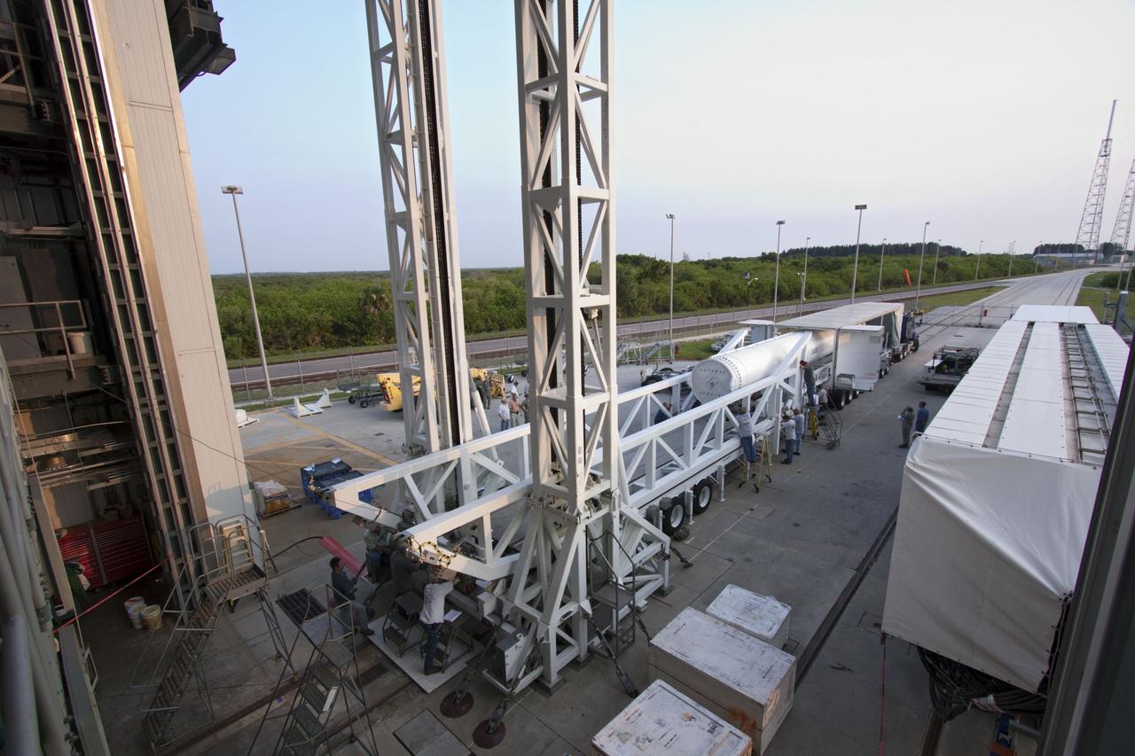 CAPE CANAVERAL, Fla. -- At Cape Canaveral Air Force Station in Florida, workers prepare the fifth and final solid rocket booster for lifting into the Vertical Integration Facility at Launch Complex 41. It then will be lifted into position and attached to the United Launch Alliance Atlas V booster stage, already at the pad.            NASA's Juno spacecraft is scheduled to launch aboard an Atlas V from Cape Canaveral, Fla. Aug. 5.The solar-powered spacecraft will orbit Jupiter's poles 33 times to find out more about the gas giant's origins, structure, atmosphere and magnetosphere and investigate the existence of a solid planetary core. For more information visit: www.nasa.gov/juno. Photo credit: NASA/Jim Grossmann