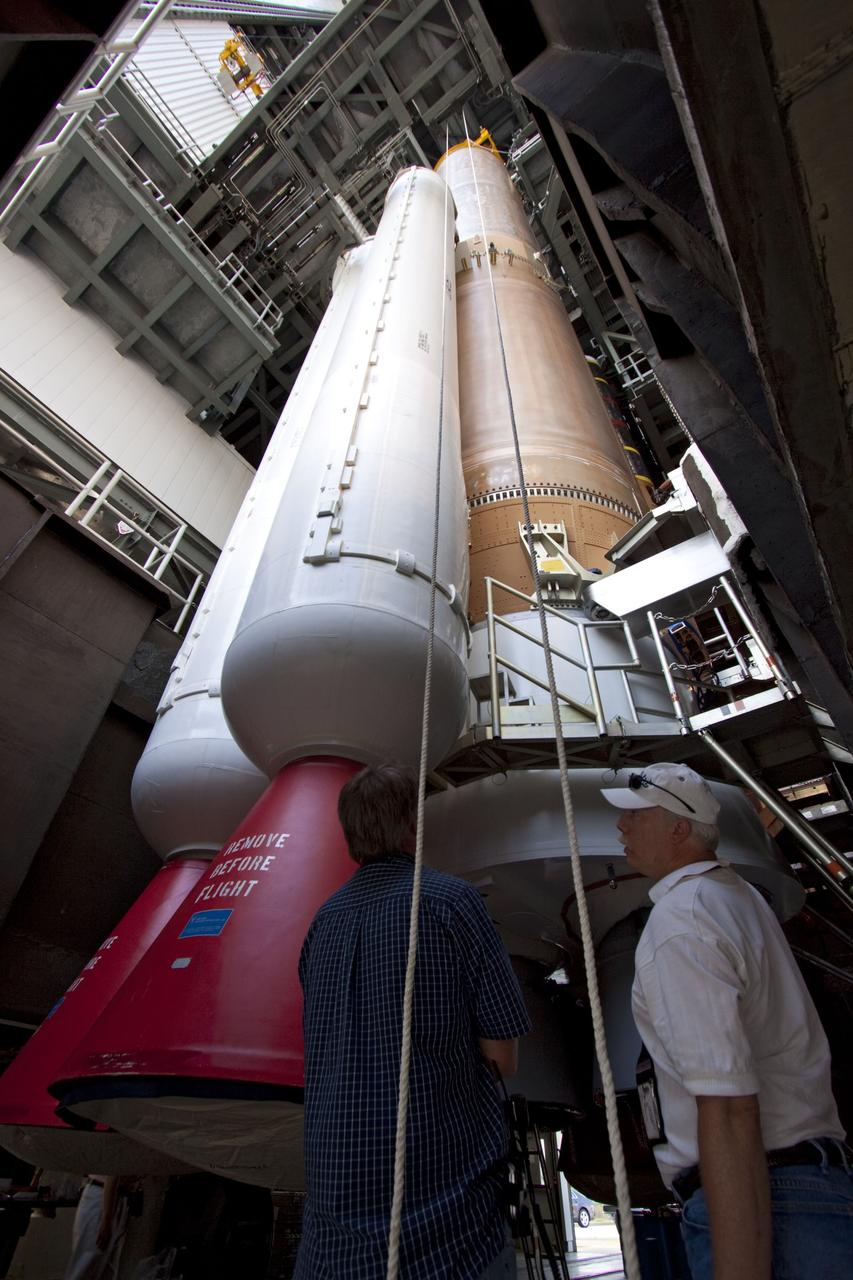CAPE CANAVERAL, Fla. -- At Cape Canaveral Air Force Station in Florida, workers prepare the fifth and final solid rocket booster for lifting into the Vertical Integration Facility at Launch Complex 41. It then will be lifted into position and attached to the United Launch Alliance Atlas V booster stage, already at the pad.            NASA's Juno spacecraft is scheduled to launch aboard an Atlas V from Cape Canaveral, Fla. Aug. 5.The solar-powered spacecraft will orbit Jupiter's poles 33 times to find out more about the gas giant's origins, structure, atmosphere and magnetosphere and investigate the existence of a solid planetary core. For more information visit: www.nasa.gov/juno. Photo credit: NASA/Jim Grossmann