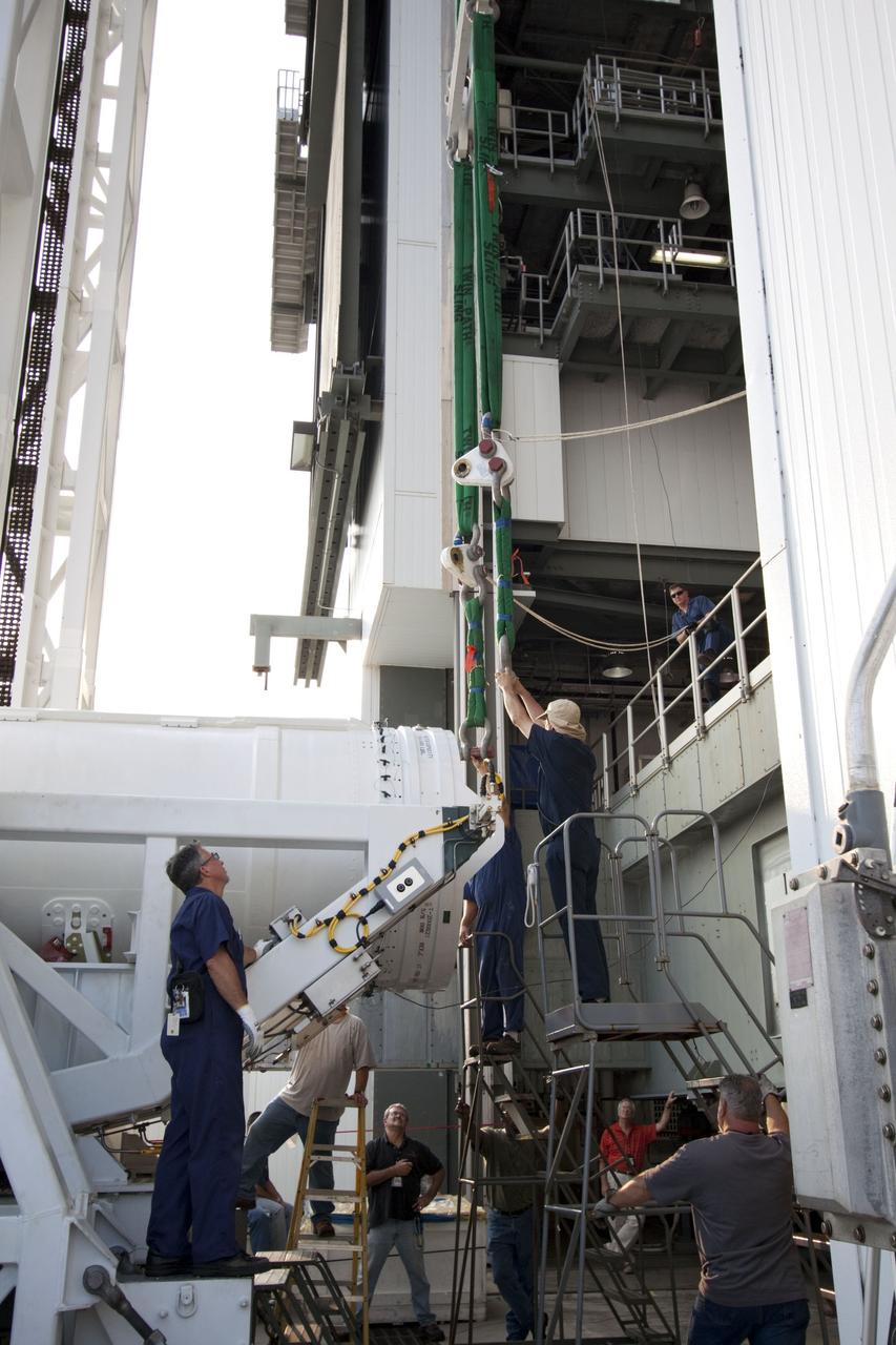 CAPE CANAVERAL, Fla. -- At Cape Canaveral Air Force Station in Florida, workers attach an overhead crane to the fifth and final solid rocket booster for lifting into the Vertical Integration Facility at Launch Complex 41. It then will be attached to the United Launch Alliance Atlas V booster stage, already at the pad.              NASA's Juno spacecraft is scheduled to launch aboard an Atlas V from Cape Canaveral, Fla. Aug. 5.The solar-powered spacecraft will orbit Jupiter's poles 33 times to find out more about the gas giant's origins, structure, atmosphere and magnetosphere and investigate the existence of a solid planetary core. For more information visit: www.nasa.gov/juno. Photo credit: NASA/Jim Grossmann