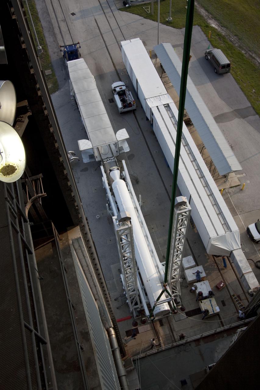 CAPE CANAVERAL, Fla. -- At Cape Canaveral Air Force Station in Florida, workers using an overhead crane lift the fifth and final solid rocket booster into the Vertical Integration Facility at Launch Complex 41. It then will be attached to the United Launch Alliance Atlas V booster stage, already at the pad.            NASA's Juno spacecraft is scheduled to launch aboard an Atlas V from Cape Canaveral, Fla. Aug. 5.The solar-powered spacecraft will orbit Jupiter's poles 33 times to find out more about the gas giant's origins, structure, atmosphere and magnetosphere and investigate the existence of a solid planetary core. For more information visit: www.nasa.gov/juno. Photo credit: NASA/Jim Grossmann