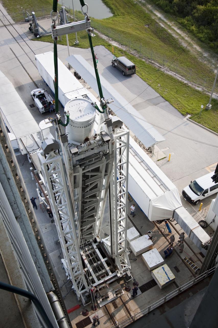 CAPE CANAVERAL, Fla. -- At Cape Canaveral Air Force Station in Florida, workers using an overhead crane lift the fifth and final solid rocket booster into the Vertical Integration Facility at Launch Complex 41. It then will be attached to the United Launch Alliance Atlas V booster stage, already at the pad.            NASA's Juno spacecraft is scheduled to launch aboard an Atlas V from Cape Canaveral, Fla. Aug. 5.The solar-powered spacecraft will orbit Jupiter's poles 33 times to find out more about the gas giant's origins, structure, atmosphere and magnetosphere and investigate the existence of a solid planetary core. For more information visit: www.nasa.gov/juno. Photo credit: NASA/Jim Grossmann