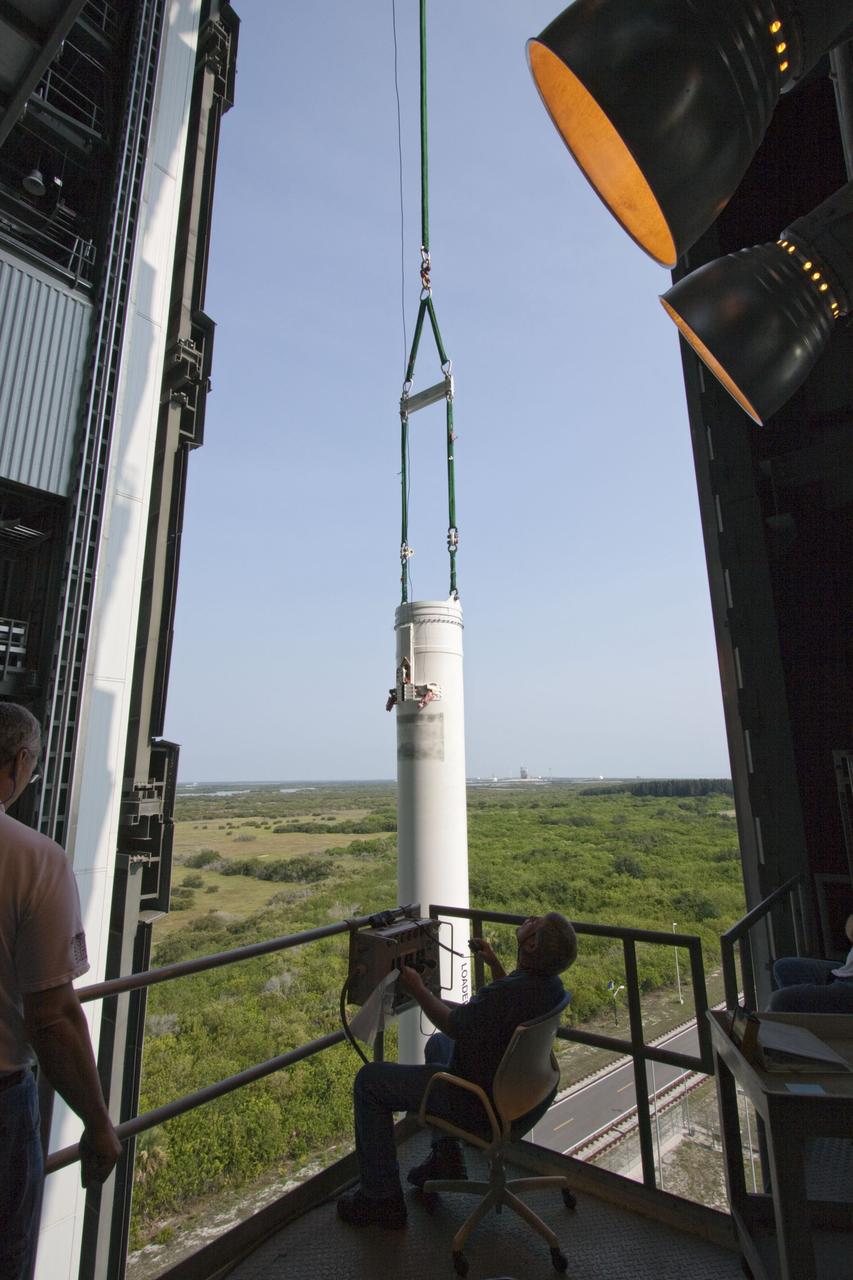 CAPE CANAVERAL, Fla. -- At Cape Canaveral Air Force Station in Florida, workers using an overhead crane lift the fifth and final solid rocket booster into the Vertical Integration Facility at Launch Complex 41. It then will be attached to the United Launch Alliance Atlas V booster stage, already at the pad.            NASA's Juno spacecraft is scheduled to launch aboard an Atlas V from Cape Canaveral, Fla. Aug. 5.The solar-powered spacecraft will orbit Jupiter's poles 33 times to find out more about the gas giant's origins, structure, atmosphere and magnetosphere and investigate the existence of a solid planetary core. For more information visit: www.nasa.gov/juno. Photo credit: NASA/Jim Grossmann