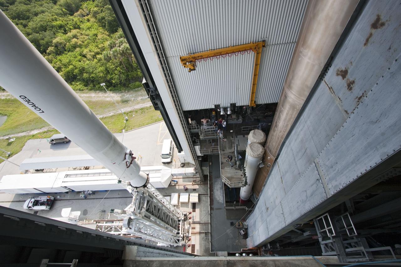 CAPE CANAVERAL, Fla. -- At Cape Canaveral Air Force Station in Florida, workers using an overhead crane lift the fifth and final solid rocket booster into the Vertical Integration Facility at Launch Complex 41. It then will be attached to the United Launch Alliance Atlas V booster stage, already at the pad.            NASA's Juno spacecraft is scheduled to launch aboard an Atlas V from Cape Canaveral, Fla. Aug. 5.The solar-powered spacecraft will orbit Jupiter's poles 33 times to find out more about the gas giant's origins, structure, atmosphere and magnetosphere and investigate the existence of a solid planetary core. For more information visit: www.nasa.gov/juno. Photo credit: NASA/Jim Grossmann