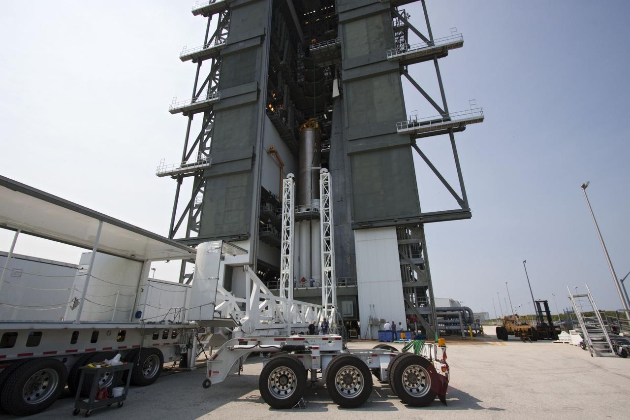 CAPE CANAVERAL, Fla. -- At Cape Canaveral Air Force Station in Florida, workers using an overhead crane lowered the fifth and final solid rocket booster into the Vertical Integration Facility at Launch Complex 41. It then will be attached to the United Launch Alliance Atlas V booster stage, already at the pad.            NASA's Juno spacecraft is scheduled to launch aboard an Atlas V from Cape Canaveral, Fla. Aug. 5.The solar-powered spacecraft will orbit Jupiter's poles 33 times to find out more about the gas giant's origins, structure, atmosphere and magnetosphere and investigate the existence of a solid planetary core. For more information visit: www.nasa.gov/juno. Photo credit: NASA/Jim Grossmann
