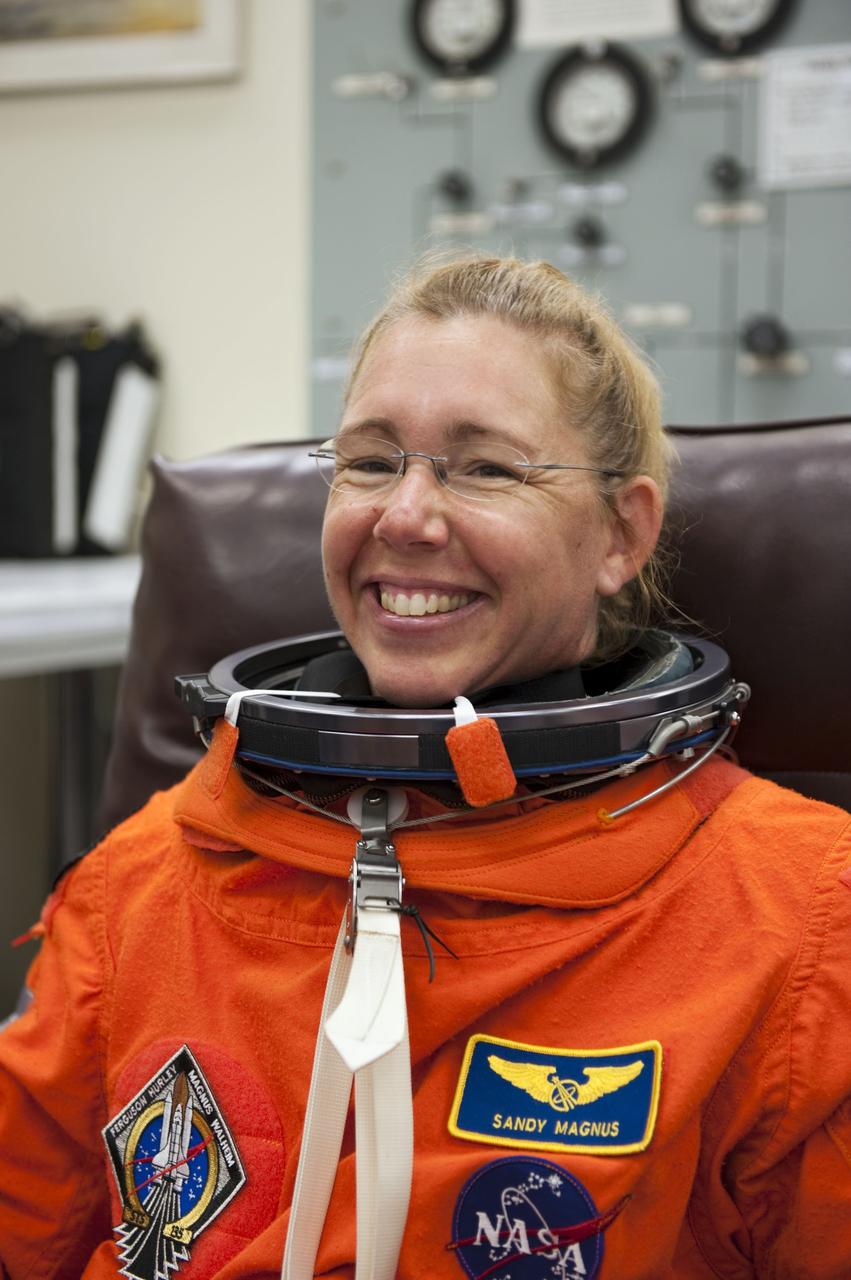CAPE CANAVERAL, Fla. -- In the Operations and Checkout Building at NASA's Kennedy Space Center in Florida, STS-135 Mission Specialist Sandy Magnus checks the fit of her launch-and-entry suit during a simulated launch countdown.             As part of the Terminal Countdown Demonstration Test (TCDT), the crew members are taken to Kennedy's Launch Pad 39A and strapped into space shuttle Atlantis to practice the steps that will be taken on launch day. Atlantis and its crew are targeted to lift off July 8, taking with them the Raffaello multi-purpose logistics module packed with supplies and spare parts to the International Space Station. The STS-135 mission also will fly a system to investigate the potential for robotically refueling existing satellites and return a failed ammonia pump module to help NASA better understand the failure mechanism and improve pump designs for future systems. STS-135 will be the 33rd flight of Atlantis, the 37th shuttle mission to the space station, and the 135th and final mission of NASA's Space Shuttle Program. For more information visit, www.nasa.gov/mission_pages/shuttle/shuttlemissions/sts135/index.html. Photo credit: NASA/Kim Shiflett