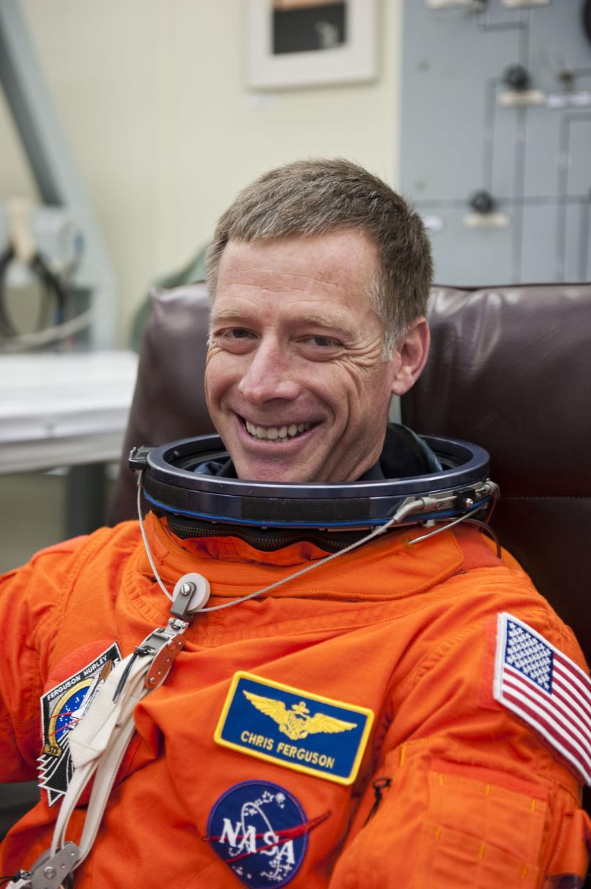 CAPE CANAVERAL, Fla. -- In the Operations and Checkout Building at NASA's Kennedy Space Center in Florida, STS-135 Commander Chris Ferguson checks the fit of his launch-and-entry suit during a simulated launch countdown.         As part of the Terminal Countdown Demonstration Test (TCDT), the crew members are taken to Kennedy's Launch Pad 39A and strapped into space shuttle Atlantis to practice the steps that will be taken on launch day. Atlantis and its crew are targeted to lift off July 8, taking with them the Raffaello multi-purpose logistics module packed with supplies and spare parts to the International Space Station. The STS-135 mission also will fly a system to investigate the potential for robotically refueling existing satellites and return a failed ammonia pump module to help NASA better understand the failure mechanism and improve pump designs for future systems. STS-135 will be the 33rd flight of Atlantis, the 37th shuttle mission to the space station, and the 135th and final mission of NASA's Space Shuttle Program. For more information visit, www.nasa.gov/mission_pages/shuttle/shuttlemissions/sts135/index.html. Photo credit: NASA/Kim Shiflett