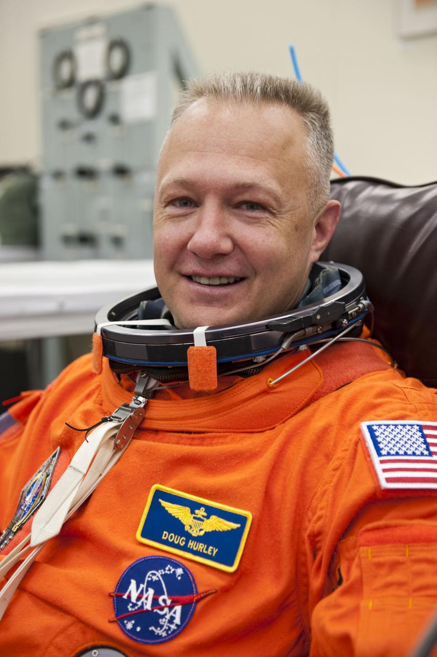 CAPE CANAVERAL, Fla. -- In the Operations and Checkout Building at NASA's Kennedy Space Center in Florida, STS-135 Pilot Doug Hurley checks the fit of his launch-and-entry suit during a simulated launch countdown.         As part of the Terminal Countdown Demonstration Test (TCDT), the crew members are taken to Kennedy's Launch Pad 39A and strapped into space shuttle Atlantis to practice the steps that will be taken on launch day. Atlantis and its crew are targeted to lift off July 8, taking with them the Raffaello multi-purpose logistics module packed with supplies and spare parts to the International Space Station. The STS-135 mission also will fly a system to investigate the potential for robotically refueling existing satellites and return a failed ammonia pump module to help NASA better understand the failure mechanism and improve pump designs for future systems. STS-135 will be the 33rd flight of Atlantis, the 37th shuttle mission to the space station, and the 135th and final mission of NASA's Space Shuttle Program. For more information visit, www.nasa.gov/mission_pages/shuttle/shuttlemissions/sts135/index.html. Photo credit: NASA/Kim Shiflett