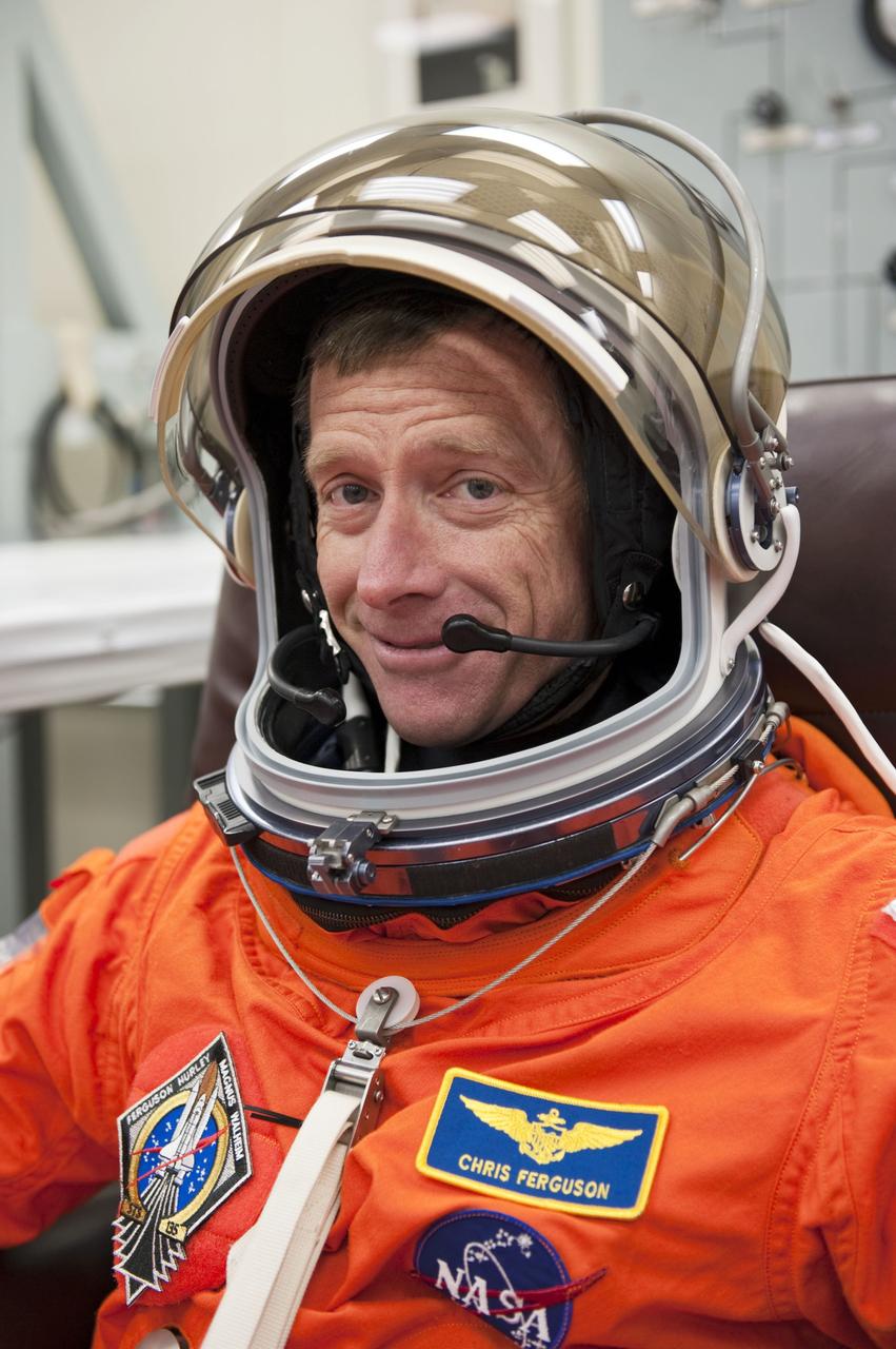 CAPE CANAVERAL, Fla. -- In the Operations and Checkout Building at NASA's Kennedy Space Center in Florida, STS-135 Commander Chris Ferguson checks the fit of his launch-and-entry suit and helmet during a simulated launch countdown.          As part of the Terminal Countdown Demonstration Test (TCDT), the crew members are taken to Kennedy's Launch Pad 39A and strapped into space shuttle Atlantis to practice the steps that will be taken on launch day. Atlantis and its crew are targeted to lift off July 8, taking with them the Raffaello multi-purpose logistics module packed with supplies and spare parts to the International Space Station. The STS-135 mission also will fly a system to investigate the potential for robotically refueling existing satellites and return a failed ammonia pump module to help NASA better understand the failure mechanism and improve pump designs for future systems. STS-135 will be the 33rd flight of Atlantis, the 37th shuttle mission to the space station, and the 135th and final mission of NASA's Space Shuttle Program. For more information visit, www.nasa.gov/mission_pages/shuttle/shuttlemissions/sts135/index.html. Photo credit: NASA/Kim Shiflett