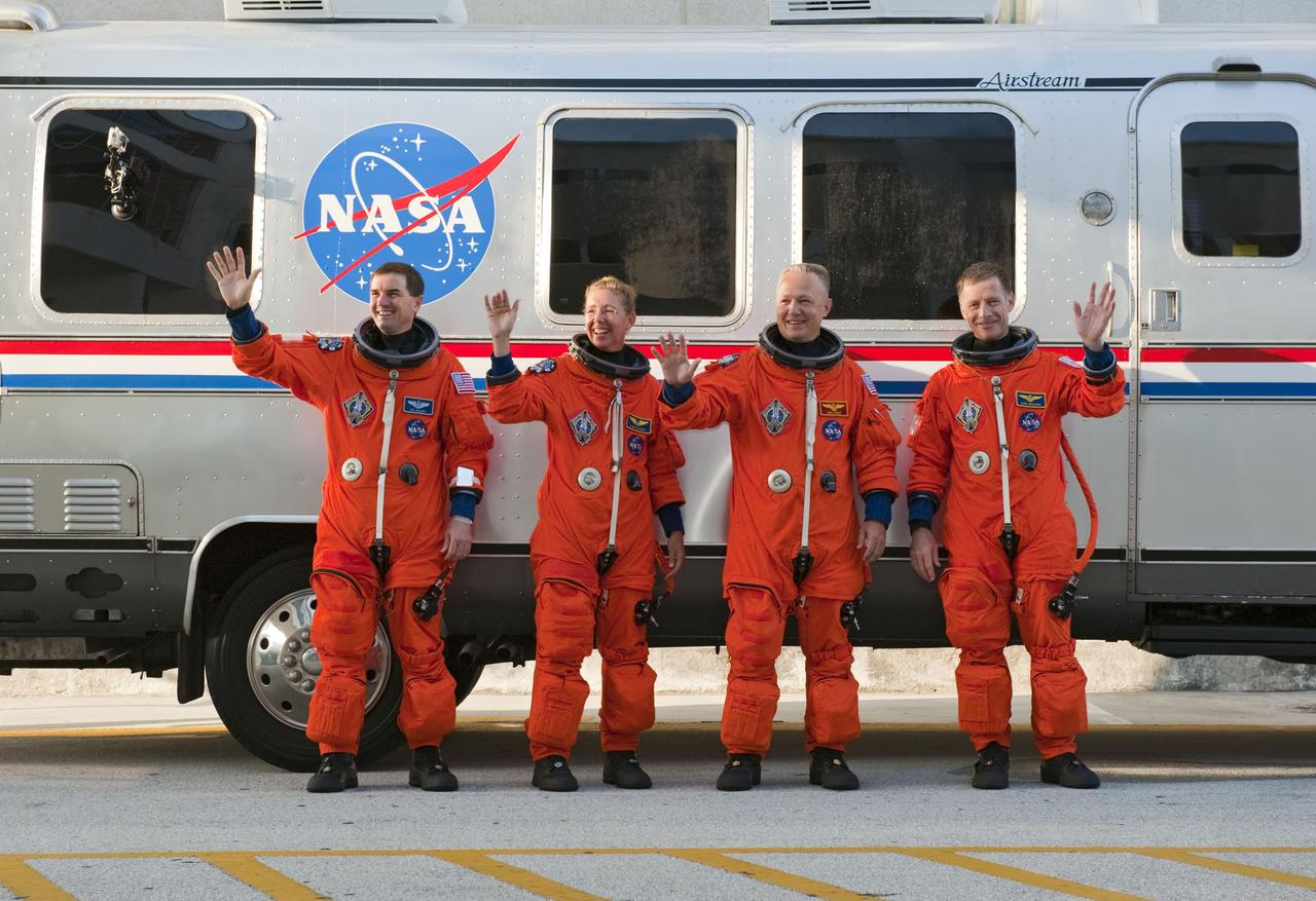 CAPE CANAVERAL, Fla. -- During a simulated launch countdown the STS-135 crew pauses for a photo and waves to Kennedy workers and media before climbing aboard the waiting Astrovan at NASA's Kennedy Space Center in Florida. As part of the Terminal Countdown Demonstration Test (TCDT), the crew members are driven to Kennedy's Launch Pad 39A and then strapped into space shuttle Atlantis to practice the steps that will be taken on launch day. From left are Mission Specialists Rex Walheim and Sandy Magnus, Pilot Doug Hurley and Commander Chris Ferguson.           Atlantis and its crew are targeted to lift off July 8, taking with them the Raffaello multi-purpose logistics module packed with supplies and spare parts to the International Space Station. The STS-135 mission also will fly a system to investigate the potential for robotically refueling existing satellites and return a failed ammonia pump module to help NASA better understand the failure mechanism and improve pump designs for future systems. STS-135 will be the 33rd flight of Atlantis, the 37th shuttle mission to the space station, and the 135th and final mission of NASA's Space Shuttle Program. For more information visit, www.nasa.gov/mission_pages/shuttle/shuttlemissions/sts135/index.html. Photo credit: NASA/Kim Shiflett