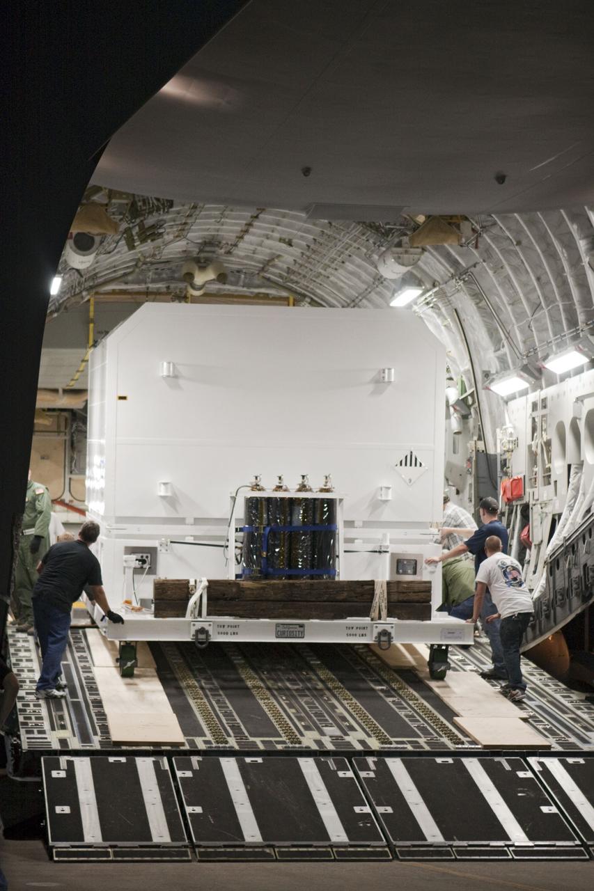 CAPE CANAVERAL, Fla. -- Workers unload a container holding NASA's Mars Science Laboratory (MSL) rover, known as Curiosity, from an Air Force C-17 cargo plane after arrival at NASA Kennedy Space Center's Shuttle Landing Facility in Florida. Already unloaded is the MSL rocket-powered descent stage that will fly the rover during the final moments before landing on Mars. A United Launch Alliance Atlas V-541 configuration will be used to loft MSL into space. Curiosity’s 10 science instruments are designed to search for evidence on whether Mars has had environments favorable to microbial life, including chemical ingredients for life. The unique rover will use a laser to look inside rocks and release its gasses so that the rover’s spectrometer can analyze and send the data back to Earth. MSL is scheduled to launch from Cape Canaveral Air Force Station in Florida Nov. 25 with a window extending to Dec. 18 and arrival at Mars Aug. 2012. For more information, visit http://www.nasa.gov/msl. Photo credit: NASA/Troy Cryder