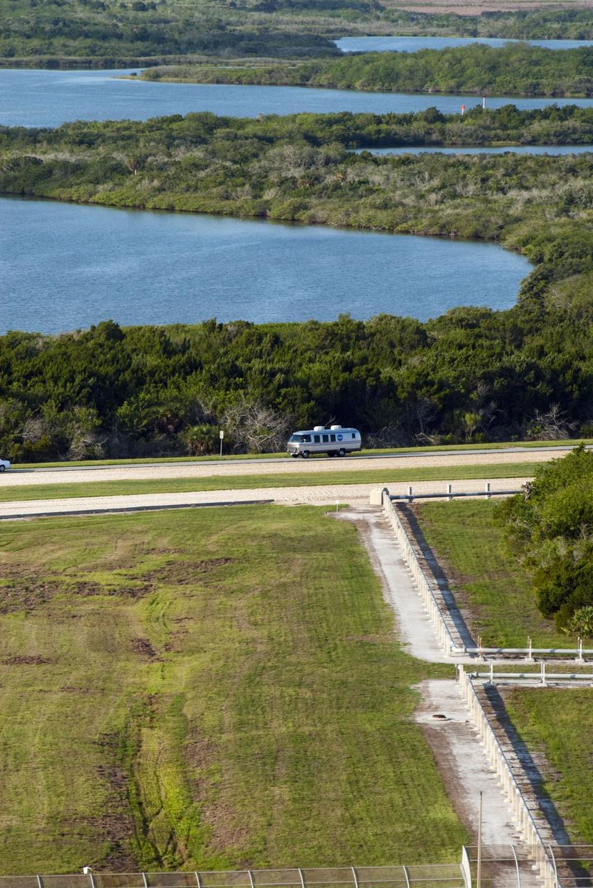 CAPE CANAVERAL, Fla. -- Seen from Launch Pad 39A at NASA's Kennedy Space Center in Florida is the silver Astrovan transporting the STS-135 crew members to the pad to participate in a launch countdown simulation exercise.           As part of the Terminal Countdown Demonstration Test (TCDT), the crew members are strapped into their seats on Atlantis to practice the steps that will be taken on launch day. Shuttle Atlantis and its crew are targeted to lift off July 8, taking with them the Raffaello multi-purpose logistics module packed with supplies and spare parts to the International Space Station. The STS-135 mission also will fly a system to investigate the potential for robotically refueling existing satellites and return a failed ammonia pump module to help NASA better understand the failure mechanism and improve pump designs for future systems. STS-135 will be the 33rd flight of Atlantis, the 37th shuttle mission to the space station, and the 135th and final mission of NASA's Space Shuttle Program. For more information visit, www.nasa.gov/mission_pages/shuttle/shuttlemissions/sts135/index.html. Photo credit: NASA/Jim Grossmann