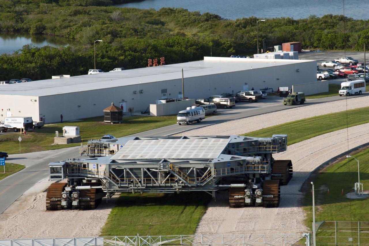 CAPE CANAVERAL, Fla. -- Seen from Launch Pad 39A at NASA's Kennedy Space Center in Florida is the silver Astrovan transporting the STS-135 crew members to the pad to participate in a launch countdown simulation exercise.           As part of the Terminal Countdown Demonstration Test (TCDT), the crew members are strapped into their seats on Atlantis to practice the steps that will be taken on launch day. Shuttle Atlantis and its crew are targeted to lift off July 8, taking with them the Raffaello multi-purpose logistics module packed with supplies and spare parts to the International Space Station. The STS-135 mission also will fly a system to investigate the potential for robotically refueling existing satellites and return a failed ammonia pump module to help NASA better understand the failure mechanism and improve pump designs for future systems. STS-135 will be the 33rd flight of Atlantis, the 37th shuttle mission to the space station, and the 135th and final mission of NASA's Space Shuttle Program. For more information visit, www.nasa.gov/mission_pages/shuttle/shuttlemissions/sts135/index.html. Photo credit: NASA/Jim Grossmann