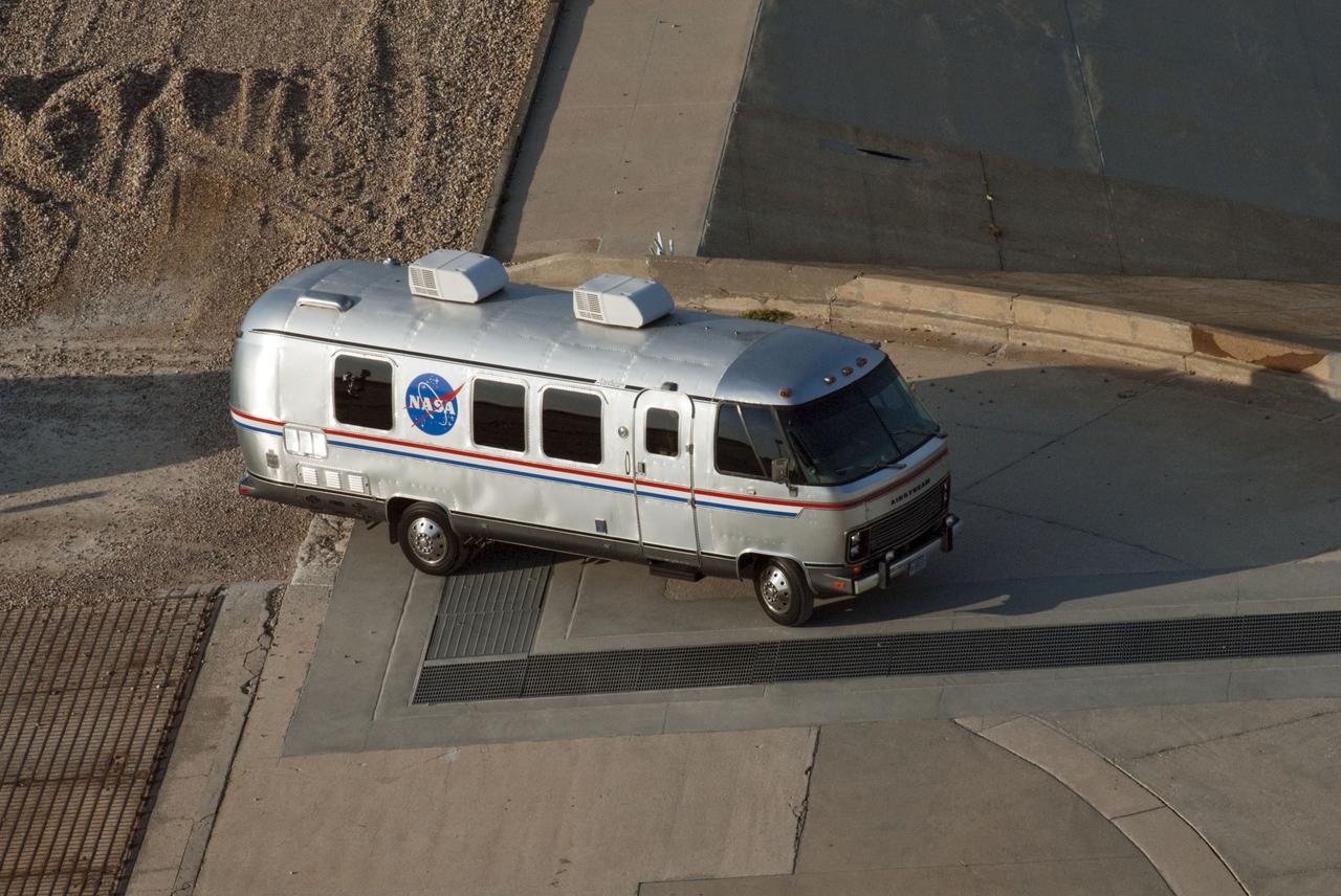 CAPE CANAVERAL, Fla. -- Seen from an upper level of Launch Pad 39A at NASA's Kennedy Space Center in Florida is the arrival of the silver Astrovan transporting the STS-135 crew members to the pad to participate in a launch countdown simulation exercise.         As part of the Terminal Countdown Demonstration Test (TCDT), the crew members are strapped into their seats on Atlantis to practice the steps that will be taken on launch day. Shuttle Atlantis and its crew are targeted to lift off July 8, taking with them the Raffaello multi-purpose logistics module packed with supplies and spare parts to the International Space Station. The STS-135 mission also will fly a system to investigate the potential for robotically refueling existing satellites and return a failed ammonia pump module to help NASA better understand the failure mechanism and improve pump designs for future systems. STS-135 will be the 33rd flight of Atlantis, the 37th shuttle mission to the space station, and the 135th and final mission of NASA's Space Shuttle Program. For more information visit, www.nasa.gov/mission_pages/shuttle/shuttlemissions/sts135/index.html. Photo credit: NASA/Jim Grossmann