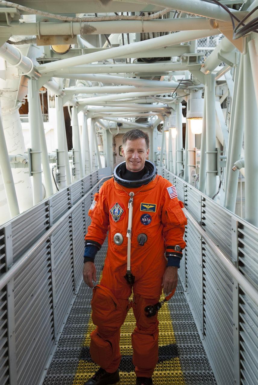 CAPE CANAVERAL, Fla. -- STS-135 Commander Chris Ferguson stands on the walkway to the White Room which provides entry to space shuttle Atlantis' crew compartment on Launch Pad 39A at NASA's Kennedy Space Center in Florida. Atlantis' crew members are at the pad to participate in a launch countdown simulation exercise.      As part of the Terminal Countdown Demonstration Test (TCDT), the crew members are strapped into their seats on Atlantis to practice the steps that will be taken on launch day. Shuttle Atlantis and its crew are targeted to lift off July 8, taking with them the Raffaello multi-purpose logistics module packed with supplies and spare parts to the International Space Station. The STS-135 mission also will fly a system to investigate the potential for robotically refueling existing satellites and return a failed ammonia pump module to help NASA better understand the failure mechanism and improve pump designs for future systems. STS-135 will be the 33rd flight of Atlantis, the 37th shuttle mission to the space station, and the 135th and final mission of NASA's Space Shuttle Program. For more information visit, www.nasa.gov/mission_pages/shuttle/shuttlemissions/sts135/index.html. Photo credit: NASA/Jim Grossmann