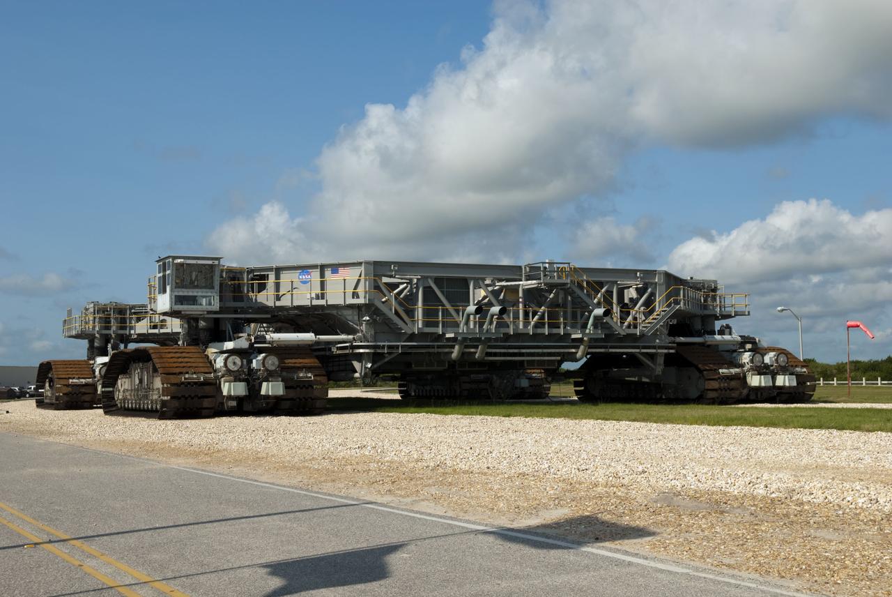 CAPE CANAVERAL, Fla. -- The massive crawler-transporter that carried space shuttle Atlantis to Launch Pad 39A at NASA's Kennedy Space Center in Florida sits serenely on the crawlerway once its transport duties were completed. Meanwhile, Atlantis' crew members are at the pad to participate in a launch countdown simulation exercise.        As part of the Terminal Countdown Demonstration Test (TCDT), the crew members are strapped into their seats on Atlantis to practice the steps that will be taken on launch day. Shuttle Atlantis and its crew are targeted to lift off July 8, taking with them the Raffaello multi-purpose logistics module packed with supplies and spare parts to the International Space Station. The STS-135 mission also will fly a system to investigate the potential for robotically refueling existing satellites and return a failed ammonia pump module to help NASA better understand the failure mechanism and improve pump designs for future systems. STS-135 will be the 33rd flight of Atlantis, the 37th shuttle mission to the space station, and the 135th and final mission of NASA's Space Shuttle Program. For more information visit, www.nasa.gov/mission_pages/shuttle/shuttlemissions/sts135/index.html. Photo credit: NASA/Jim Grossmann
