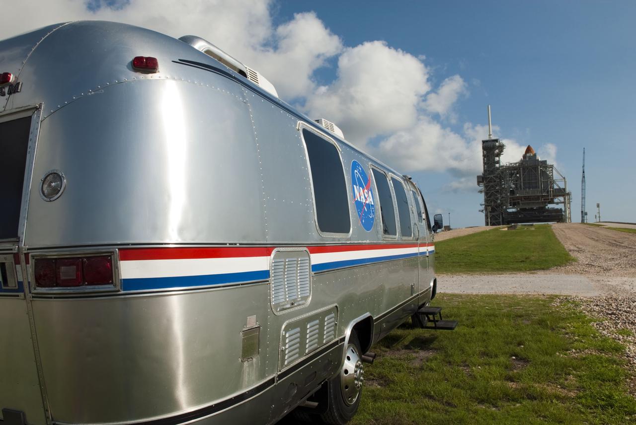 CAPE CANAVERAL, Fla. -- NASA's silver Astrovan is parked below Launch Pad 39A at NASA's Kennedy Space Center in Florida after delivering space shuttle Atlantis' STS-135 crew members to the pad to participate in a launch countdown simulation exercise. The Astrovan will return the astronauts to the Operations and Checkout Building at the end of their training.      As part of the Terminal Countdown Demonstration Test (TCDT), the crew members are strapped into their seats on Atlantis to practice the steps that will be taken on launch day. Shuttle Atlantis and its crew are targeted to lift off July 8, taking with them the Raffaello multi-purpose logistics module packed with supplies and spare parts to the International Space Station. The STS-135 mission also will fly a system to investigate the potential for robotically refueling existing satellites and return a failed ammonia pump module to help NASA better understand the failure mechanism and improve pump designs for future systems. STS-135 will be the 33rd flight of Atlantis, the 37th shuttle mission to the space station, and the 135th and final mission of NASA's Space Shuttle Program. For more information visit, www.nasa.gov/mission_pages/shuttle/shuttlemissions/sts135/index.html. Photo credit: NASA/Jim Grossmann