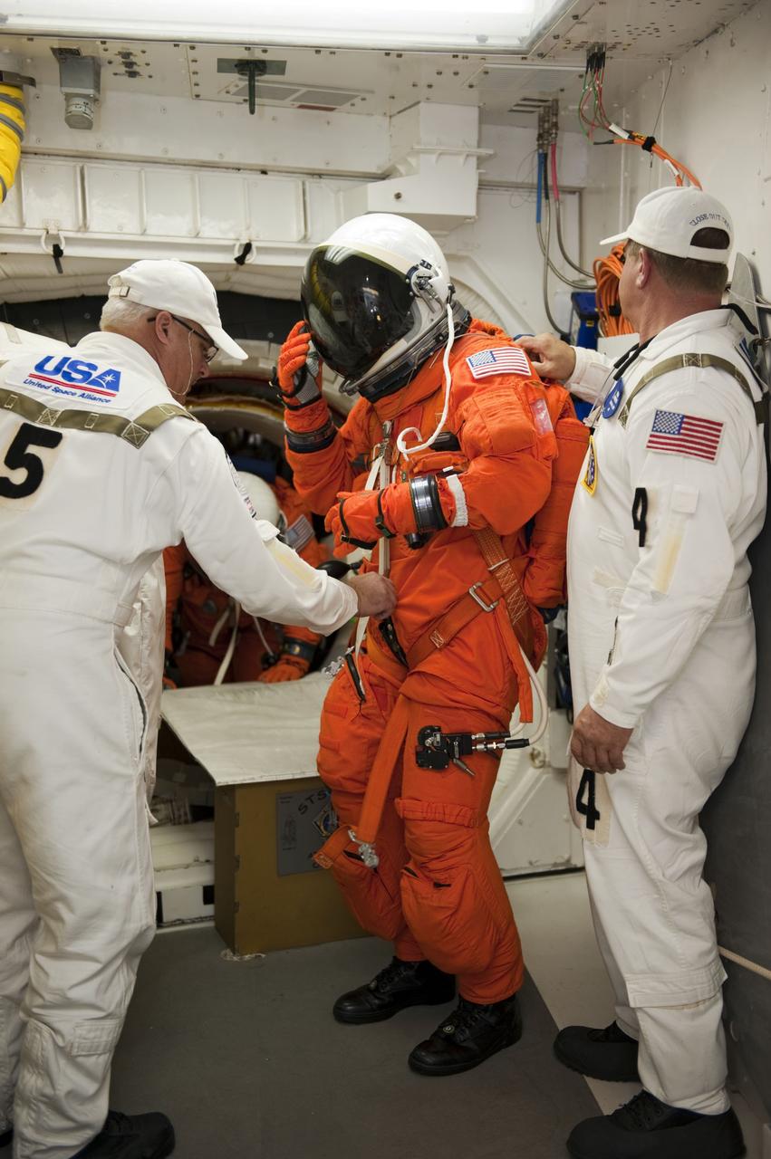 CAPE CANAVERAL, Fla. -- During simulated pad emergency exit training on Launch Pad 39A at NASA's Kennedy Space Center in Florida, STS-135 crew members, assisted by the Closeout Crew, make their way out of space shuttle Atlantis into the White Room toward slidewire baskets that would take them to a safe bunker below the pad in the unlikely event of an emergency.               The exercise is part of the Terminal Countdown Demonstration Test (TCDT) and related training. Atlantis and its crew are targeted to lift off July 8, taking with them the Raffaello multi-purpose logistics module packed with supplies and spare parts to the International Space Station. The STS-135 mission also will fly a system to investigate the potential for robotically refueling existing satellites and return a failed ammonia pump module to help NASA better understand the failure mechanism and improve pump designs for future systems. STS-135 will be the 33rd flight of Atlantis, the 37th shuttle mission to the space station, and the 135th and final mission of NASA's Space Shuttle Program. For more information visit, www.nasa.gov/mission_pages/shuttle/shuttlemissions/sts135/index.html. Photo credit: NASA/Kim Shiflett