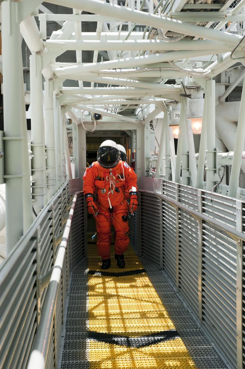 CAPE CANAVERAL, Fla. -- During simulated pad emergency exit training on Launch Pad 39A at NASA's Kennedy Space Center in Florida, the STS-135 crew members make their way out of the White Room toward slidewire baskets that would take them to a safe bunker below the pad in the unlikely event of an emergency.             The exercise is part of the Terminal Countdown Demonstration Test (TCDT) and related training. Atlantis and its crew are targeted to lift off July 8, taking with them the Raffaello multi-purpose logistics module packed with supplies and spare parts to the International Space Station. The STS-135 mission also will fly a system to investigate the potential for robotically refueling existing satellites and return a failed ammonia pump module to help NASA better understand the failure mechanism and improve pump designs for future systems. STS-135 will be the 33rd flight of Atlantis, the 37th shuttle mission to the space station, and the 135th and final mission of NASA's Space Shuttle Program. For more information visit, www.nasa.gov/mission_pages/shuttle/shuttlemissions/sts135/index.html. Photo credit: NASA/Kim Shiflett