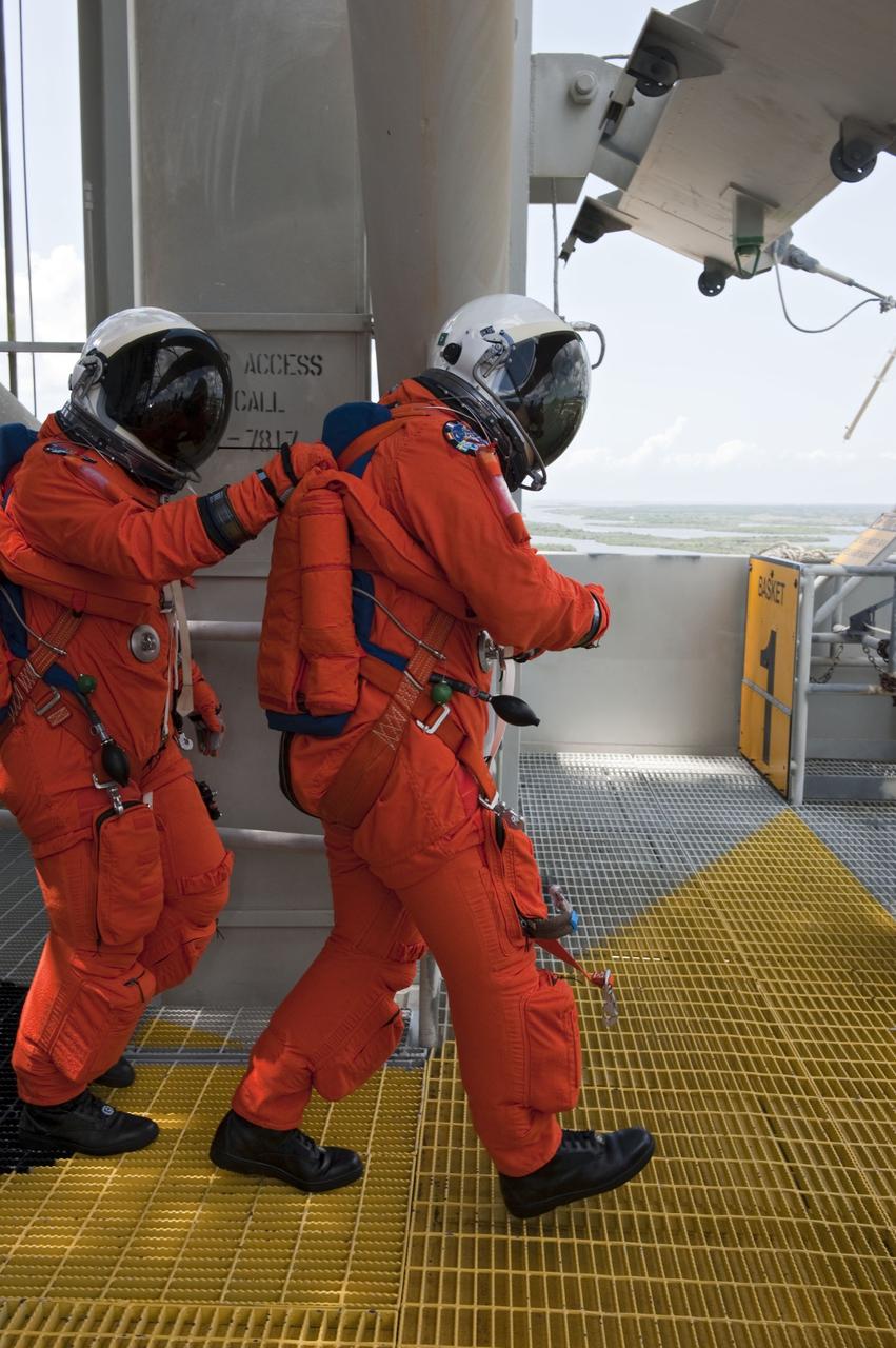 CAPE CANAVERAL, Fla. -- During simulated pad emergency exit training on Launch Pad 39A at NASA's Kennedy Space Center in Florida, the STS-135 crew members make their way toward slidewire baskets that would take them to a safe bunker below the pad in the unlikely event of an emergency.          The exercise is part of the Terminal Countdown Demonstration Test (TCDT) and related training. Atlantis and its crew are targeted to lift off July 8, taking with them the Raffaello multi-purpose logistics module packed with supplies and spare parts to the International Space Station. The STS-135 mission also will fly a system to investigate the potential for robotically refueling existing satellites and return a failed ammonia pump module to help NASA better understand the failure mechanism and improve pump designs for future systems. STS-135 will be the 33rd flight of Atlantis, the 37th shuttle mission to the space station, and the 135th and final mission of NASA's Space Shuttle Program. For more information visit, www.nasa.gov/mission_pages/shuttle/shuttlemissions/sts135/index.html. Photo credit: NASA/Kim Shiflett
