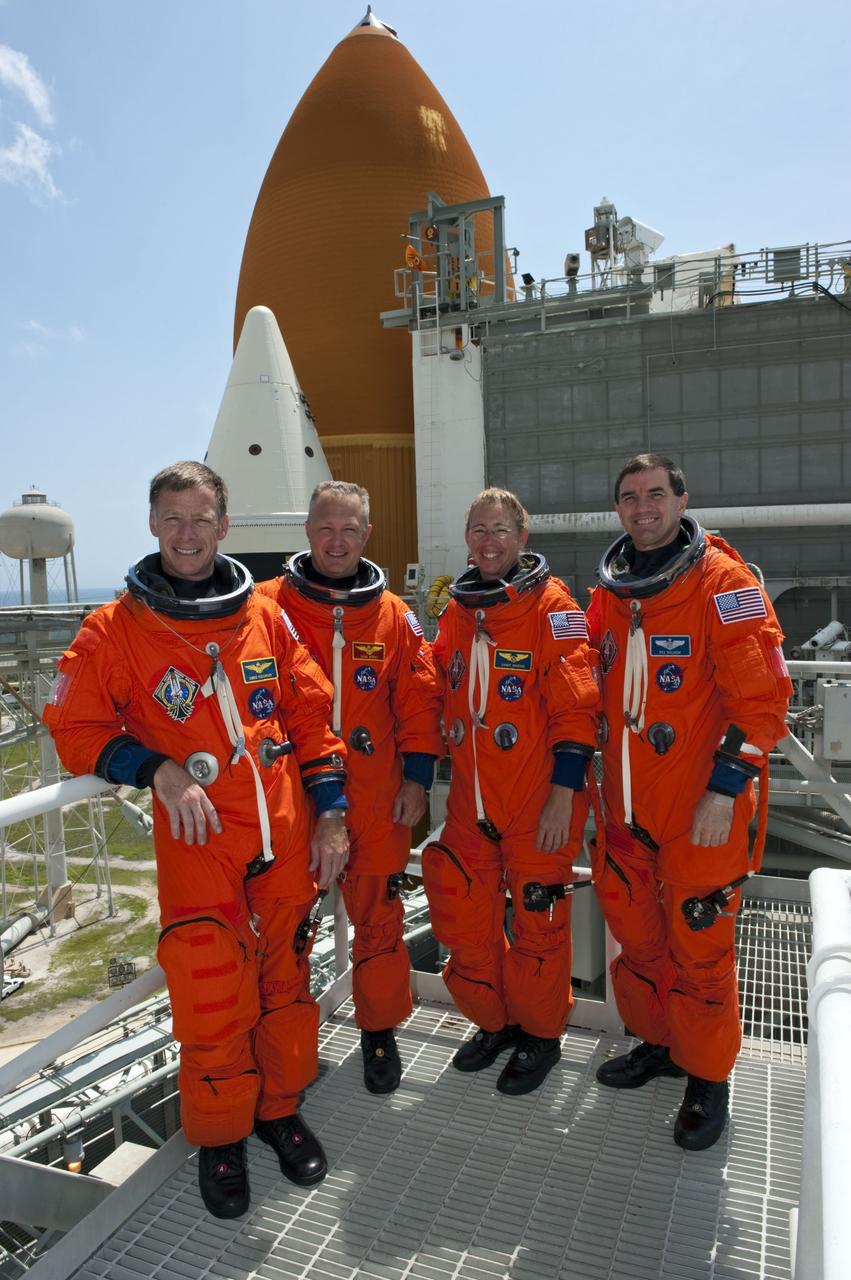 CAPE CANAVERAL, Fla. -- After completing simulated pad emergency exit training on Launch Pad 39A at NASA's Kennedy Space Center in Florida, the STS-135 crew members pause for a photo. From left are Commander Chris Ferguson, Pilot Doug Hurley, Mission Specialists Sandy Magnus and Rex Walheim.           The exercise is part of the Terminal Countdown Demonstration Test (TCDT) and related training. Atlantis and its crew are targeted to lift off July 8, taking with them the Raffaello multi-purpose logistics module packed with supplies and spare parts to the International Space Station. The STS-135 mission also will fly a system to investigate the potential for robotically refueling existing satellites and return a failed ammonia pump module to help NASA better understand the failure mechanism and improve pump designs for future systems. STS-135 will be the 33rd flight of Atlantis, the 37th shuttle mission to the space station, and the 135th and final mission of NASA's Space Shuttle Program. For more information visit, www.nasa.gov/mission_pages/shuttle/shuttlemissions/sts135/index.html. Photo credit: NASA/Kim Shiflett