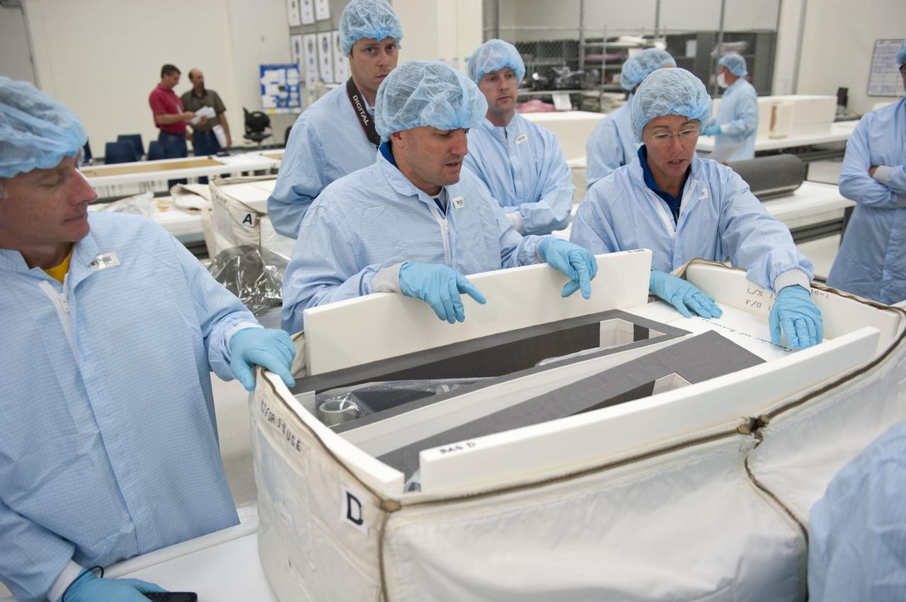 CAPE CANAVERAL, Fla. -- During the bench review of systems and hardware in the Space Station Processing Facility at NASA's Kennedy Space Center in Florida, space shuttle Atlantis' STS-135 crew members get a close look at some of the equipment they'll use in space. The astronauts dressed in clean-room attire, known as "bunny suits" are (from right to left) Mission Specialists Sandy Magnus and Rex Walheim and Commander Chris Ferguson.                The review is part of the Terminal Countdown Demonstration Test (TCDT) and related training. Atlantis and its crew are targeted to lift off July 8, taking with them the Raffaello multi-purpose logistics module packed with supplies and spare parts to the International Space Station. The STS-135 mission also will fly a system to investigate the potential for robotically refueling existing satellites and return a failed ammonia pump module to help NASA better understand the failure mechanism and improve pump designs for future systems. STS-135 will be the 33rd flight of Atlantis, the 37th shuttle mission to the space station, and the 135th and final mission of NASA's Space Shuttle Program. For more information visit, www.nasa.gov/mission_pages/shuttle/shuttlemissions/sts135/index.html. Photo credit: NASA/Kim Shiflett