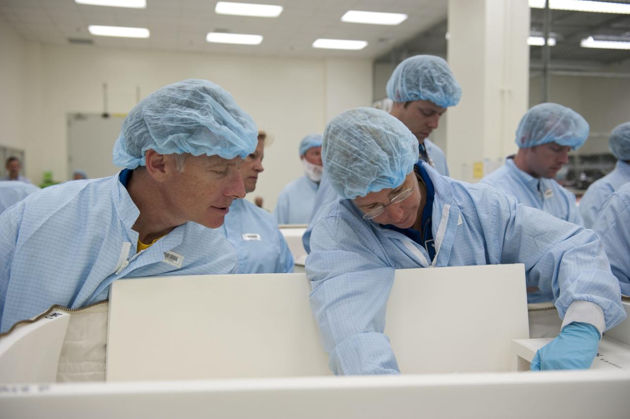 CAPE CANAVERAL, Fla. -- During the bench review of systems and hardware in the Space Station Processing Facility at NASA's Kennedy Space Center in Florida, space shuttle Atlantis' STS-135 crew members get a close look at some of the equipment they'll use in space. The astronauts dressed in clean-room attire, known as "bunny suits" are Commander Chris Ferguson (left) and Mission Specialist Sandy Magnus.            The review is part of the Terminal Countdown Demonstration Test (TCDT) and related training. Atlantis and its crew are targeted to lift off July 8, taking with them the Raffaello multi-purpose logistics module packed with supplies and spare parts to the International Space Station. The STS-135 mission also will fly a system to investigate the potential for robotically refueling existing satellites and return a failed ammonia pump module to help NASA better understand the failure mechanism and improve pump designs for future systems. STS-135 will be the 33rd flight of Atlantis, the 37th shuttle mission to the space station, and the 135th and final mission of NASA's Space Shuttle Program. For more information visit, www.nasa.gov/mission_pages/shuttle/shuttlemissions/sts135/index.html. Photo credit: NASA/Kim Shiflett