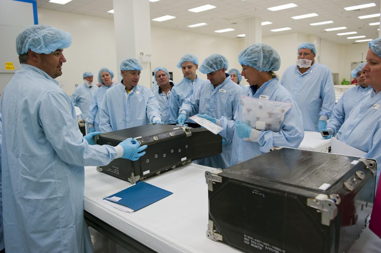 CAPE CANAVERAL, Fla. -- During the bench review of systems and hardware in the Space Station Processing Facility at NASA's Kennedy Space Center in Florida, space shuttle Atlantis' STS-135 crew members get a close look at some of the equipment they'll use in space. The astronauts dressed in clean-room attire, known as "bunny suits" are Mission Specialists Sandy Magnus (right) and Rex Walheim and Commander Chris Ferguson.        The review is part of the Terminal Countdown Demonstration Test (TCDT) and related training. Atlantis and its crew are targeted to lift off July 8, taking with them the Raffaello multi-purpose logistics module packed with supplies and spare parts to the International Space Station. The STS-135 mission also will fly a system to investigate the potential for robotically refueling existing satellites and return a failed ammonia pump module to help NASA better understand the failure mechanism and improve pump designs for future systems. STS-135 will be the 33rd flight of Atlantis, the 37th shuttle mission to the space station, and the 135th and final mission of NASA's Space Shuttle Program. For more information visit, www.nasa.gov/mission_pages/shuttle/shuttlemissions/sts135/index.html. Photo credit: NASA/Kim Shiflett
