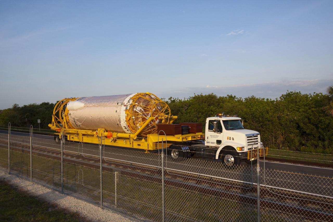 CAPE CANAVERAL, Fla. -- At Cape Canaveral Air Force Station in Florida, the Centaur upper stage for the United Launch Alliance Atlas V, slated to launch NASA's Juno spacecraft, is being transported from the Atlas Spaceflight Operations Center for delivery to Launch Complex 41. It then will be lifted into the Vertical Integration Facility and attached to the Atlas V booster stage, already at the pad.          Juno is scheduled to launch aboard an Atlas V from Cape Canaveral, Fla. Aug. 5.The solar-powered spacecraft will orbit Jupiter's poles 33 times to find out more about the gas giant's origins, structure, atmosphere and magnetosphere and investigate the existence of a solid planetary core. For more information visit: www.nasa.gov/juno. Photo credit: NASA/Jim Grossmann