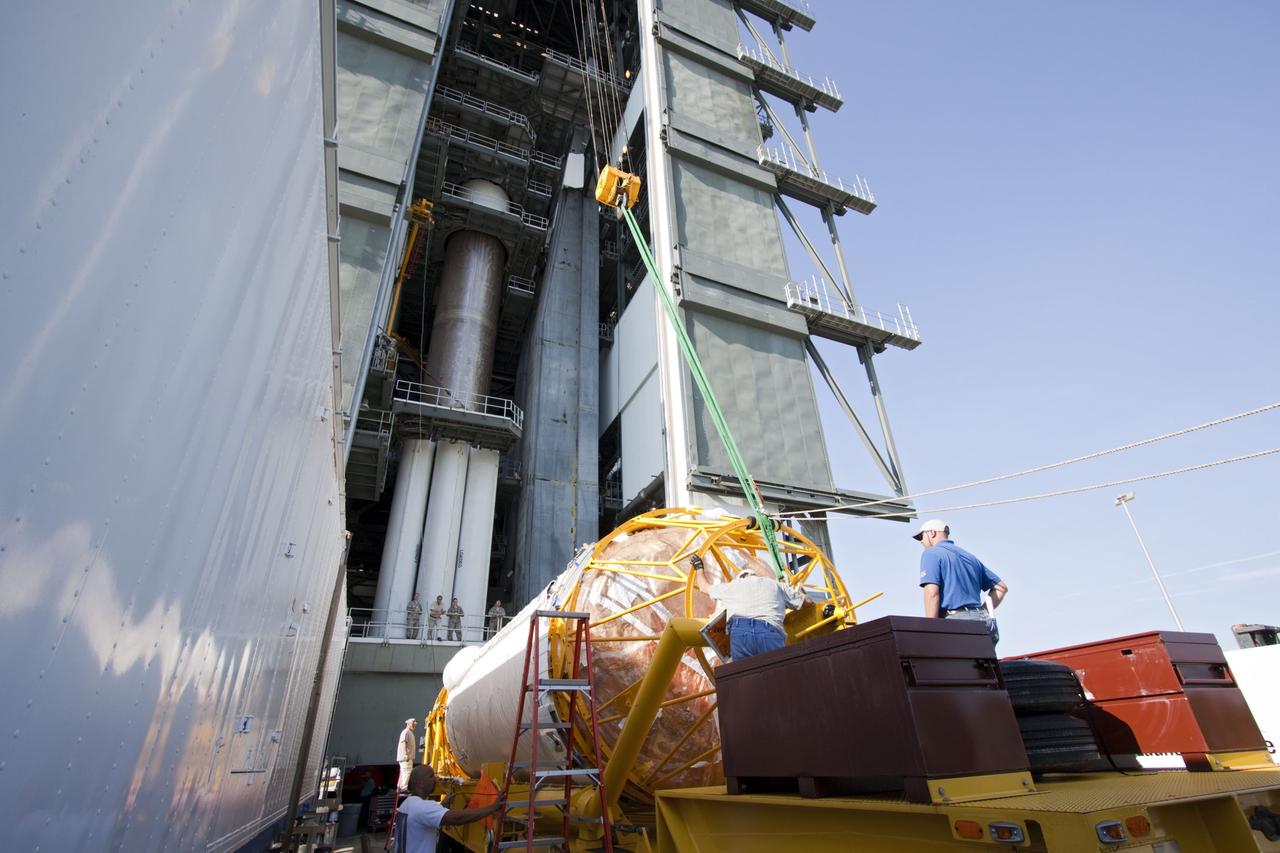 CAPE CANAVERAL, Fla. -- At Launch Complex 41 at Cape Canaveral Air Force Station in Florida, workers attach an overhead crane to the Centaur upper stage for the United Launch Alliance Atlas V, slated to launch NASA's Juno spacecraft, into the Vertical Integration Facility (VIF). After in position in the VIF it will be attached to the Atlas V booster stage, already at the pad. Juno is scheduled to launch aboard an Atlas V from Cape Canaveral, Fla. Aug. 5.The solar-powered spacecraft will orbit Jupiter's poles 33 times to find out more about the gas giant's origins, structure, atmosphere and magnetosphere and investigate the existence of a solid planetary core. For more information visit: www.nasa.gov/juno. Photo credit: NASA/Jim Grossmann