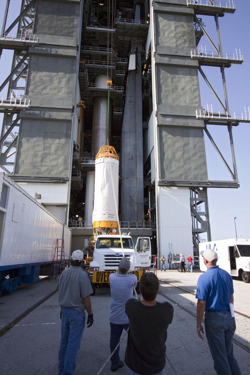 CAPE CANAVERAL, Fla. -- At Launch Complex 41 at Cape Canaveral Air Force Station in Florida, workers guide an overhead crane as it lifts the Centaur upper stage for the United Launch Alliance Atlas V, slated to launch NASA's Juno spacecraft, into the Vertical Integration Facility (VIF). After in position in the VIF it will be attached to the Atlas V booster stage, already at the pad.        Juno is scheduled to launch aboard an Atlas V from Cape Canaveral, Fla. Aug. 5.The solar-powered spacecraft will orbit Jupiter's poles 33 times to find out more about the gas giant's origins, structure, atmosphere and magnetosphere and investigate the existence of a solid planetary core. For more information visit: www.nasa.gov/juno. Photo credit: NASA/Jim Grossmann