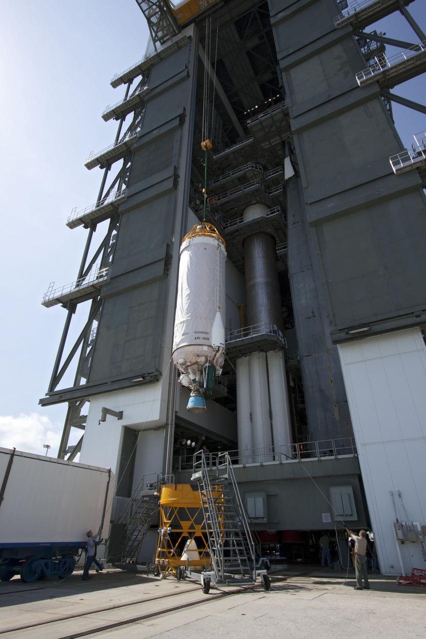 CAPE CANAVERAL, Fla. -- At Launch Complex 41 at Cape Canaveral Air Force Station in Florida, workers guide an overhead crane as it lifts the Centaur upper stage for the United Launch Alliance Atlas V, slated to launch NASA's Juno spacecraft, into the Vertical Integration Facility (VIF). After in position in the VIF it will be attached to the Atlas V booster stage, already at the pad.        Juno is scheduled to launch aboard an Atlas V from Cape Canaveral, Fla. Aug. 5.The solar-powered spacecraft will orbit Jupiter's poles 33 times to find out more about the gas giant's origins, structure, atmosphere and magnetosphere and investigate the existence of a solid planetary core. For more information visit: www.nasa.gov/juno. Photo credit: NASA/Jim Grossmann