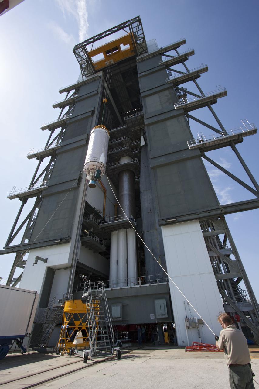 CAPE CANAVERAL, Fla. -- At Launch Complex 41 at Cape Canaveral Air Force Station in Florida, workers guide an overhead crane as it lifts the Centaur upper stage for the United Launch Alliance Atlas V, slated to launch NASA's Juno spacecraft, into the Vertical Integration Facility (VIF). After in position in the VIF it will be attached to the Atlas V booster stage, already at the pad. Juno is scheduled to launch aboard an Atlas V from Cape Canaveral, Fla. Aug. 5.The solar-powered spacecraft will orbit Jupiter's poles 33 times to find out more about the gas giant's origins, structure, atmosphere and magnetosphere and investigate the existence of a solid planetary core. For more information visit: www.nasa.gov/juno. Photo credit: NASA/Jim Grossmann
