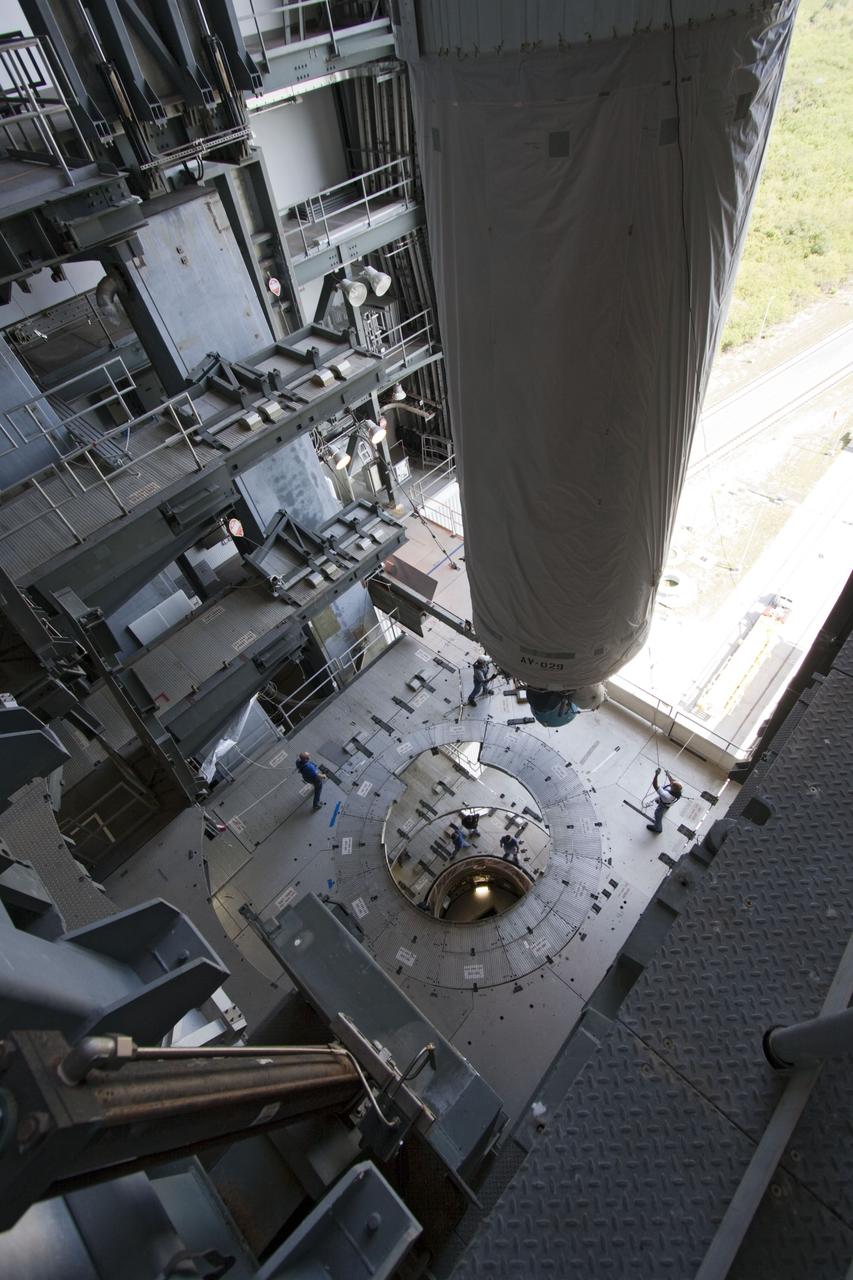 CAPE CANAVERAL, Fla. -- At Launch Complex 41 at Cape Canaveral Air Force Station in Florida, workers guide an overhead crane as it lifts the Centaur upper stage for the United Launch Alliance Atlas V, slated to launch NASA's Juno spacecraft, into the Vertical Integration Facility (VIF). After in position in the VIF it will be attached to the Atlas V booster stage, already at the pad.        Juno is scheduled to launch aboard an Atlas V from Cape Canaveral, Fla. Aug. 5.The solar-powered spacecraft will orbit Jupiter's poles 33 times to find out more about the gas giant's origins, structure, atmosphere and magnetosphere and investigate the existence of a solid planetary core. For more information visit: www.nasa.gov/juno. Photo credit: NASA/Jim Grossmann