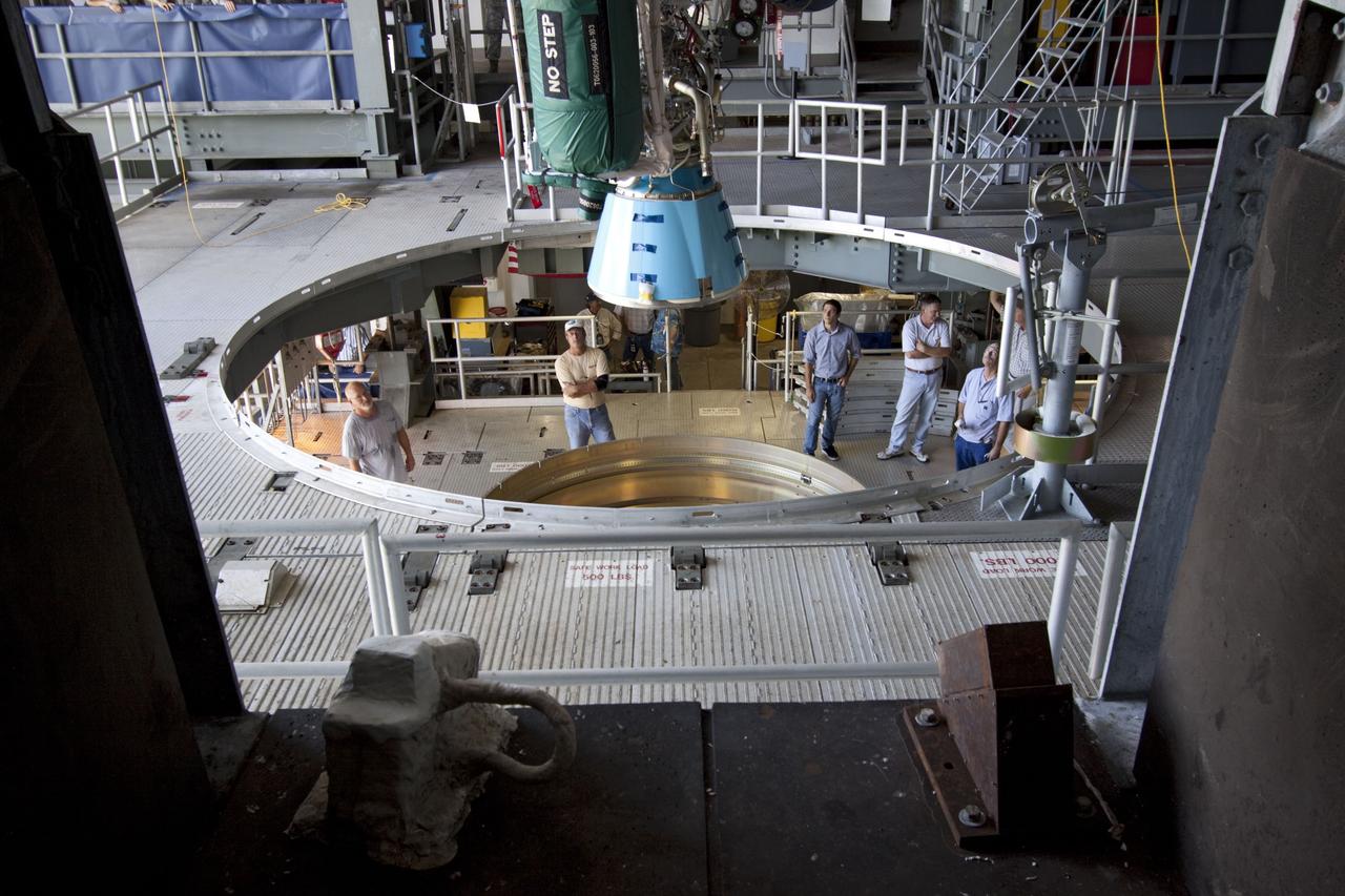 CAPE CANAVERAL, Fla. -- At Launch Complex 41 at Cape Canaveral Air Force Station in Florida, workers monitor an overhead crane as it lowers the Centaur upper stage for the United Launch Alliance Atlas V, slated to launch NASA's Juno spacecraft, into position in the Vertical Integration Facility (VIF). It then will be attached to the Atlas V booster stage, already at the pad.          Juno is scheduled to launch aboard an Atlas V from Cape Canaveral, Fla. Aug. 5.The solar-powered spacecraft will orbit Jupiter's poles 33 times to find out more about the gas giant's origins, structure, atmosphere and magnetosphere and investigate the existence of a solid planetary core. For more information visit: www.nasa.gov/juno. Photo credit: NASA/Jim Grossmann
