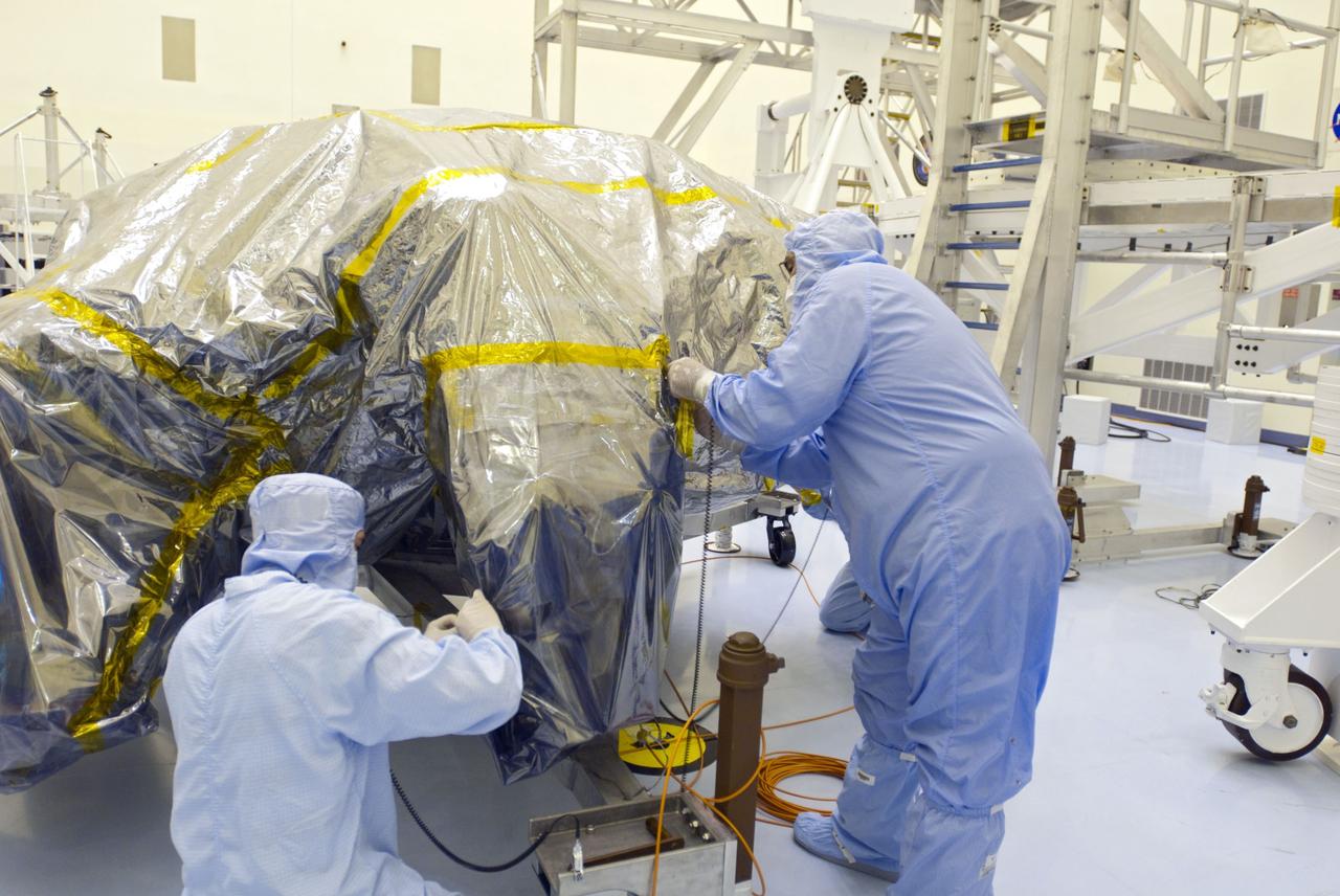 Cape Canaveral, Fla. -- At the Payload Hazardous Servicing Facility at NASA's Kennedy Space Center in Florida, technicians begin to unwrap the protective cover from NASA's Mars Science Laboratory (MSL) rocket-powered descent stage thrusters for documenting and inspection. The descent stage will fly the MSL rover, Curiosity, during the final moments before landing on Mars.          A United Launch Alliance Atlas V-541 configuration will be used to loft MSL into space. Curiosity’s 10 science instruments are designed to search for evidence on whether Mars has had environments favorable to microbial life, including chemical ingredients for life.  The unique rover will use a laser to look inside rocks and release its gasses so that the rover’s spectrometer can analyze and send the data back to Earth. MSL is scheduled to launch from Cape Canaveral Air Force Station in Florida Nov. 25 with a window extending to Dec. 18 and arrival at Mars Aug. 2012. For more information, visit http://www.nasa.gov/msl. Photo credit: NASA/Charisse Nahser