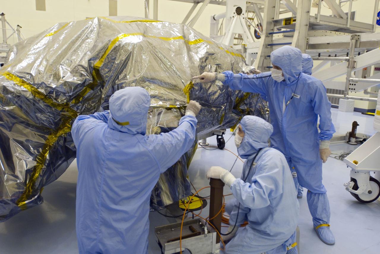 Cape Canaveral, Fla. -- At the Payload Hazardous Servicing Facility at NASA's Kennedy Space Center in Florida, technicians begin to unwrap the protective cover from NASA's Mars Science Laboratory (MSL) rocket-powered descent stage thrusters for documenting and inspection. The descent stage will fly the MSL rover, Curiosity, during the final moments before landing on Mars.          A United Launch Alliance Atlas V-541 configuration will be used to loft MSL into space. Curiosity’s 10 science instruments are designed to search for evidence on whether Mars has had environments favorable to microbial life, including chemical ingredients for life.  The unique rover will use a laser to look inside rocks and release its gasses so that the rover’s spectrometer can analyze and send the data back to Earth. MSL is scheduled to launch from Cape Canaveral Air Force Station in Florida Nov. 25 with a window extending to Dec. 18 and arrival at Mars Aug. 2012. For more information, visit http://www.nasa.gov/msl. Photo credit: NASA/Charisse Nahser