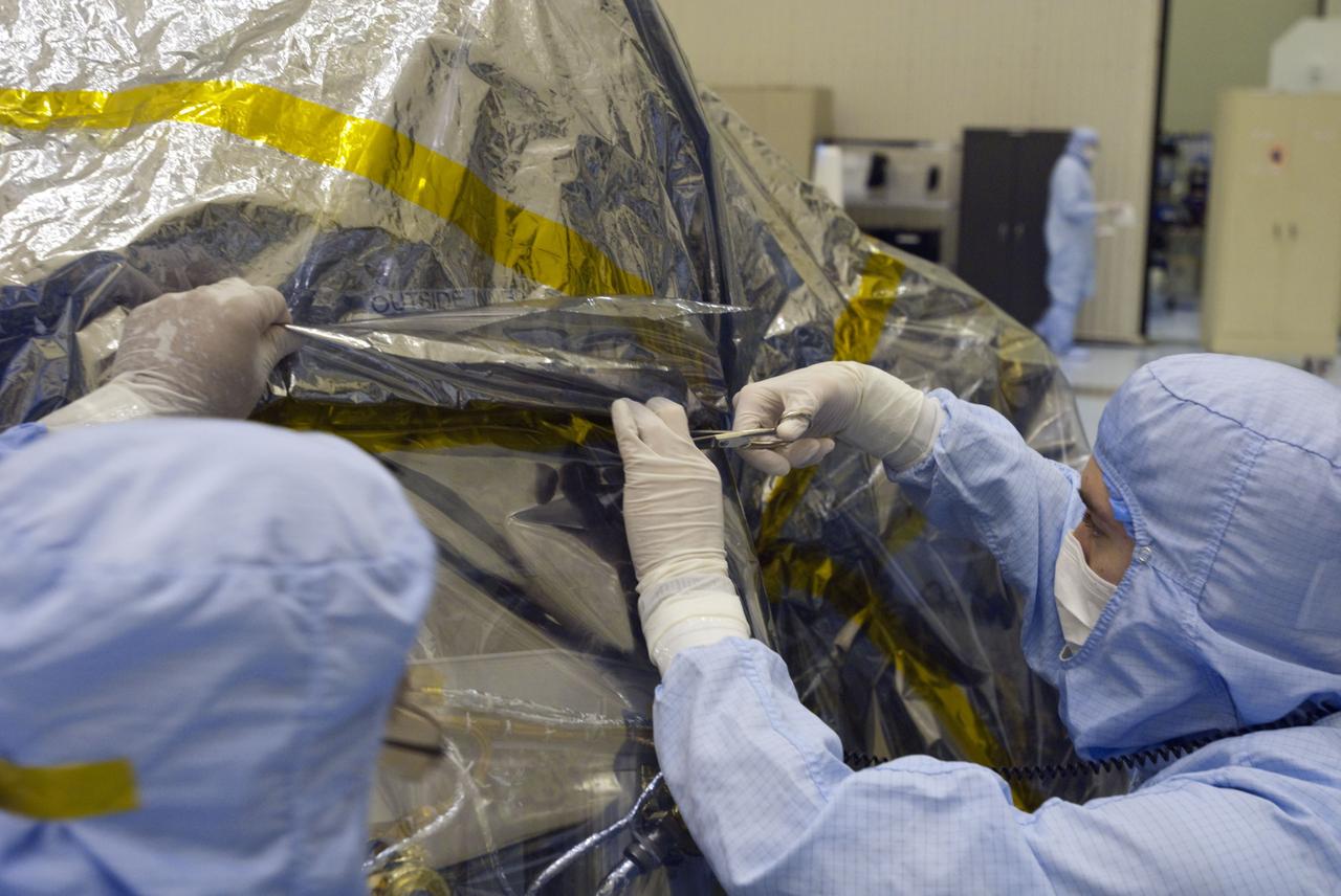 Cape Canaveral, Fla. -- At the Payload Hazardous Servicing Facility at NASA's Kennedy Space Center in Florida, technicians remove the protective wrapping from the next set of NASA's Mars Science Laboratory (MSL) rocket-powered descent stage thrusters for documenting and inspection. The descent stage will fly the MSL rover, Curiosity, during the final moments before landing on Mars. A United Launch Alliance Atlas V-541 configuration will be used to loft MSL into space. Curiosity’s 10 science instruments are designed to search for evidence on whether Mars has had environments favorable to microbial life, including chemical ingredients for life. The unique rover will use a laser to look inside rocks and release its gasses so that the rover’s spectrometer can analyze and send the data back to Earth. MSL is scheduled to launch from Cape Canaveral Air Force Station in Florida Nov. 25 with a window extending to Dec. 18 and arrival at Mars Aug. 2012. For more information, visit http://www.nasa.gov/msl. Photo credit: NASA/Charisse Nahser