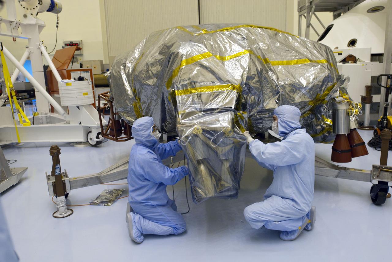 Cape Canaveral, Fla. -- At the Payload Hazardous Servicing Facility at NASA's Kennedy Space Center in Florida, technicians remove the protective wrapping from the next set of NASA's Mars Science Laboratory (MSL) rocket-powered descent stage thrusters for documenting and inspection. The descent stage will fly the MSL rover, Curiosity, during the final moments before landing on Mars. A United Launch Alliance Atlas V-541 configuration will be used to loft MSL into space. Curiosity’s 10 science instruments are designed to search for evidence on whether Mars has had environments favorable to microbial life, including chemical ingredients for life. The unique rover will use a laser to look inside rocks and release its gasses so that the rover’s spectrometer can analyze and send the data back to Earth. MSL is scheduled to launch from Cape Canaveral Air Force Station in Florida Nov. 25 with a window extending to Dec. 18 and arrival at Mars Aug. 2012. For more information, visit http://www.nasa.gov/msl. Photo credit: NASA/Charisse Nahser