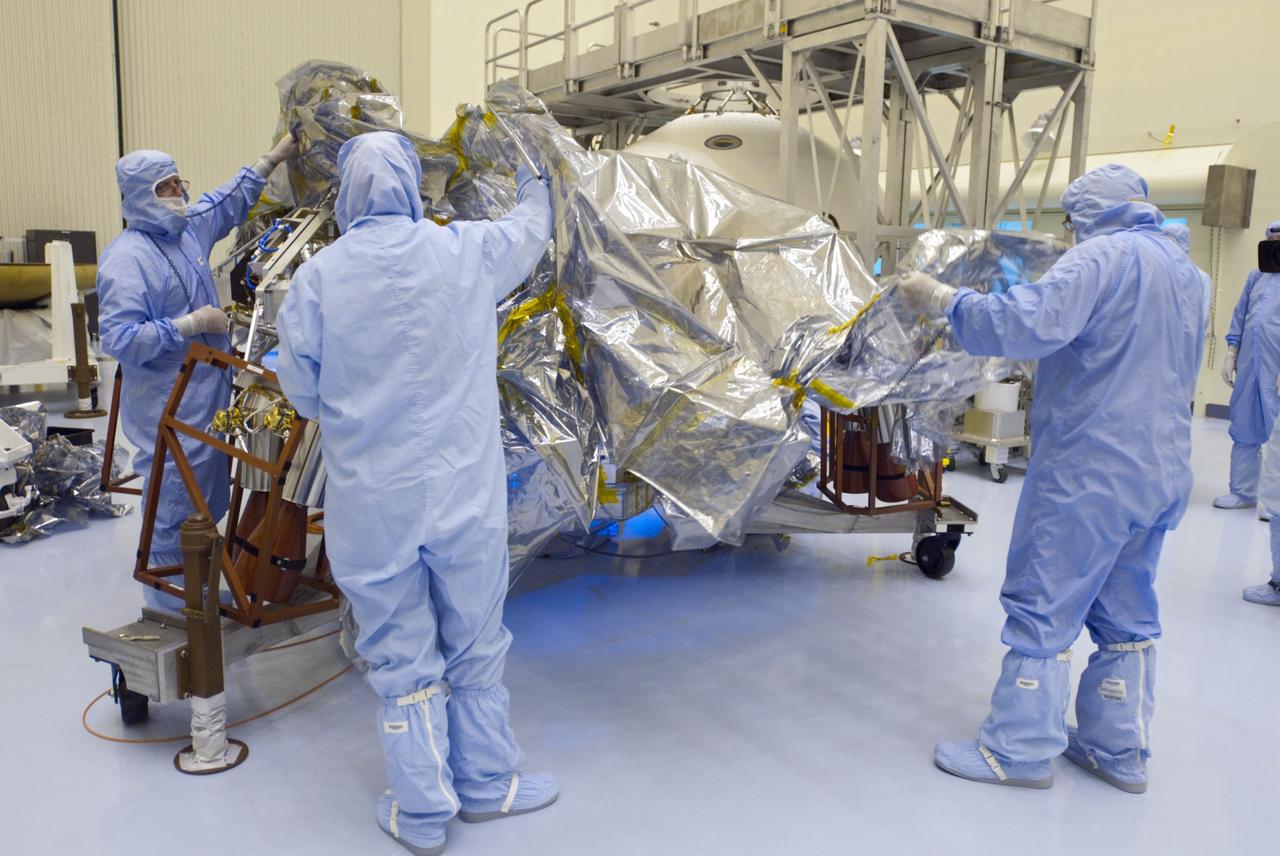Cape Canaveral, Fla. -- At the Payload Hazardous Servicing Facility at NASA's Kennedy Space Center in Florida, technicians remove the protective wrapping from the rocket-powered descent stage for NASA's Mars Science Laboratory (MSL). The descent stage will fly the MSL rover, Curiosity, during the final moments before landing on Mars. A United Launch Alliance Atlas V-541 configuration will be used to loft MSL into space. Curiosity’s 10 science instruments are designed to search for evidence on whether Mars has had environments favorable to microbial life, including chemical ingredients for life. The unique rover will use a laser to look inside rocks and release its gasses so that the rover’s spectrometer can analyze and send the data back to Earth. MSL is scheduled to launch from Cape Canaveral Air Force Station in Florida Nov. 25 with a window extending to Dec. 18 and arrival at Mars Aug. 2012. For more information, visit http://www.nasa.gov/msl. Photo credit: NASA/Charisse Nahser