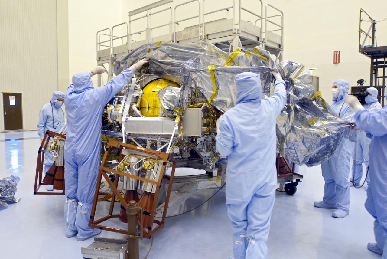 Cape Canaveral, Fla. -- At the Payload Hazardous Servicing Facility at NASA's Kennedy Space Center in Florida, technicians remove the protective wrapping from the rocket-powered descent stage for NASA's Mars Science Laboratory (MSL). The descent stage will fly the MSL rover, Curiosity, during the final moments before landing on Mars. A United Launch Alliance Atlas V-541 configuration will be used to loft MSL into space. Curiosity’s 10 science instruments are designed to search for evidence on whether Mars has had environments favorable to microbial life, including chemical ingredients for life. The unique rover will use a laser to look inside rocks and release its gasses so that the rover’s spectrometer can analyze and send the data back to Earth. MSL is scheduled to launch from Cape Canaveral Air Force Station in Florida Nov. 25 with a window extending to Dec. 18 and arrival at Mars Aug. 2012. For more information, visit http://www.nasa.gov/msl. Photo credit: NASA/Charisse Nahser