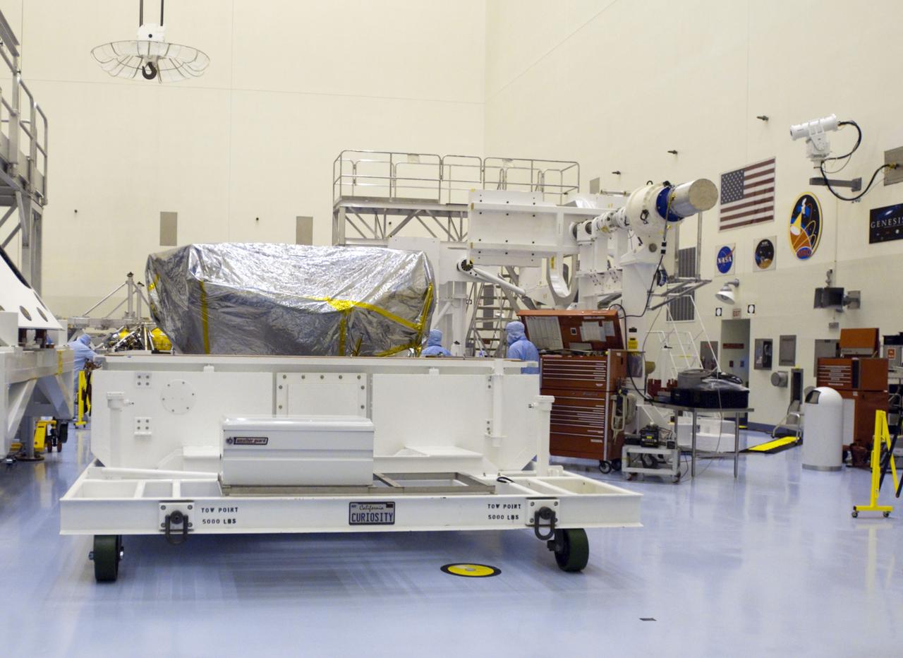 Cape Canaveral, Fla. -- At the Payload Hazardous Servicing Facility at NASA's Kennedy Space Center in Florida, workers removed the container cover from NASA's Mars Science Laboratory (MSL) rover, known as Curiosity. A United Launch Alliance Atlas V-541 configuration will be used to loft MSL into space. Curiosity’s 10 science instruments are designed to search for evidence on whether Mars has had environments favorable to microbial life, including chemical ingredients for life. The unique rover will use a laser to look inside rocks and release its gasses so that the rover’s spectrometer can analyze and send the data back to Earth. MSL is scheduled to launch from Cape Canaveral Air Force Station in Florida Nov. 25 with a window extending to Dec. 18 and arrival at Mars Aug. 2012. For more information, visit http://www.nasa.gov/msl. Photo credit: NASA/Charisse Nahser