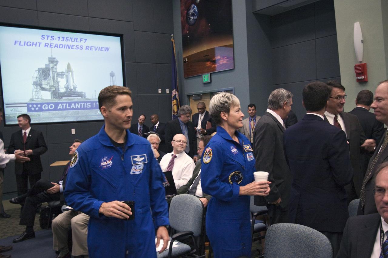 CAPE CANAVERAL, Fla. -- In the Operations Support Building II at NASA's Kennedy Space Center in Florida, Space Shuttle Program and mission managers meet for the traditional Flight Readiness Review, a thorough assessment of preparations for the mission. Seen here in blue flight suits are NASA astronauts James P. Dutton Jr. and Peggy Whitson, chief of the Astronaut Corps. The June 28 meeting is designed to produce a number of key decisions about Atlantis' STS-135 mission, including the announcement of an official launch date. Atlantis and its crew are targeted to lift off July 8, taking with them the Raffaello multi-purpose logistics module packed with supplies and spare parts to the International Space Station. The STS-135 mission also will fly a system to investigate the potential for robotically refueling existing satellites and return a failed ammonia pump module to help NASA better understand the failure mechanism and improve pump designs for future systems. STS-135 will be the 33rd flight of Atlantis, the 37th shuttle mission to the space station, and the 135th and final mission of NASA's Space Shuttle Program. For more information visit, www.nasa.gov/mission_pages/shuttle/shuttlemissions/sts135/index.html. Photo credit: Jim Grossmann
