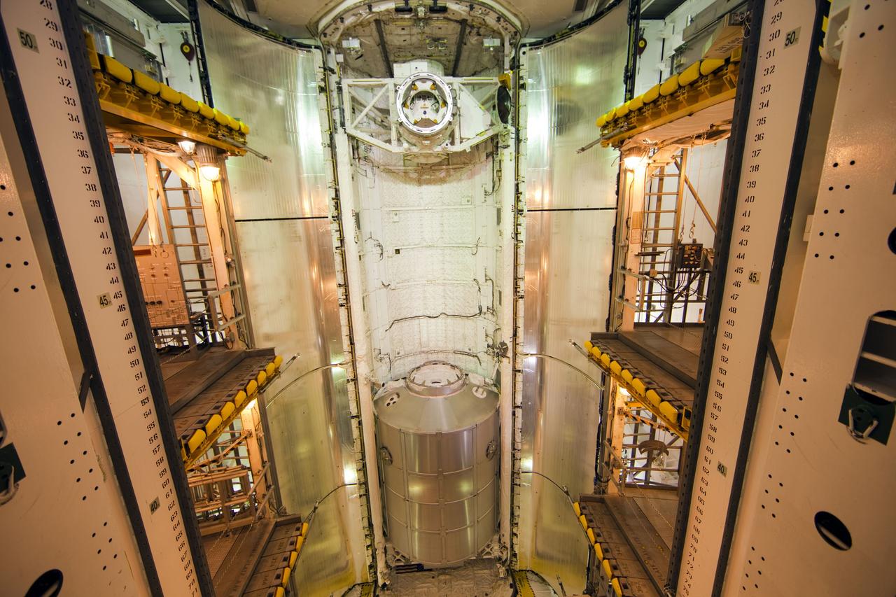 CAPE CANAVERAL, Fla. -- At Launch Pad 39A at NASA's Kennedy Space Center in Florida, work is under way to close space shuttle Atlantis' payload bay doors around the Raffaello multi-purpose logistics module (MPLM) payload for Atlantis' STS-135 mission to the International Space Station.            Commander Chris Ferguson, Pilot Doug Hurley and Mission Specialists Sandra Magnus and Rex Walheim are slated to lift off on July 8, taking with them the MPLM packed with supplies and spare parts to the station. The STS-135 mission also will fly a system to investigate the potential for robotically refueling existing satellites and return a failed ammonia pump module to help NASA better understand the failure mechanism and improve pump designs for future systems. STS-135 will be the 33rd flight of Atlantis, the 37th shuttle mission to the space station, and the 135th and final mission of NASA's Space Shuttle Program. For more information visit, www.nasa.gov/mission_pages/shuttle/shuttlemissions/sts135/index.html. Photo credit: NASA/Frank Michaux