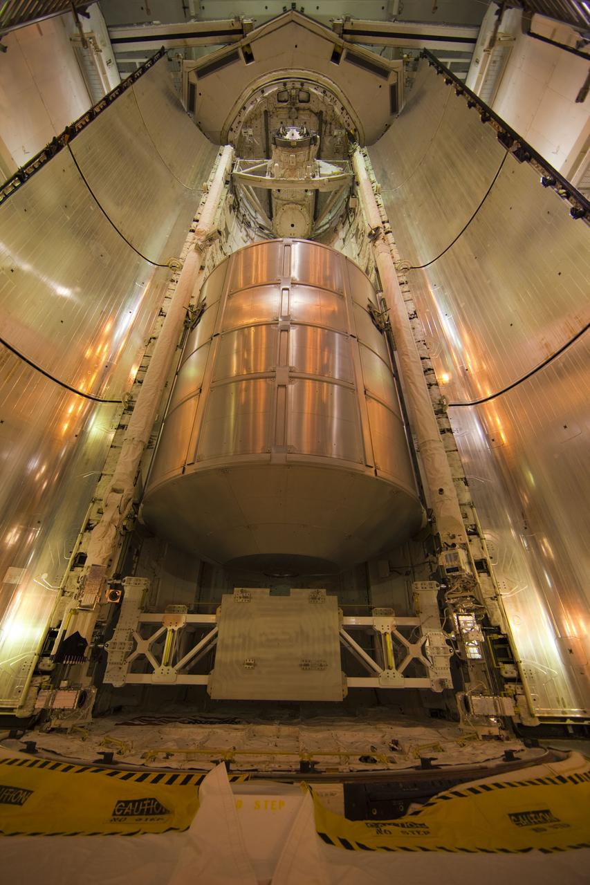 CAPE CANAVERAL, Fla. -- At Launch Pad 39A at NASA's Kennedy Space Center in Florida, space shuttle Atlantis' payload bay doors begin to close around the Raffaello multi-purpose logistics module (MPLM) payload for Atlantis' STS-135 mission to the International Space Station.      Commander Chris Ferguson, Pilot Doug Hurley and Mission Specialists Sandra Magnus and Rex Walheim are slated to lift off on July 8, taking with them the MPLM packed with supplies and spare parts to the station. The STS-135 mission also will fly a system to investigate the potential for robotically refueling existing satellites and return a failed ammonia pump module to help NASA better understand the failure mechanism and improve pump designs for future systems. STS-135 will be the 33rd flight of Atlantis, the 37th shuttle mission to the space station, and the 135th and final mission of NASA's Space Shuttle Program. For more information visit, www.nasa.gov/mission_pages/shuttle/shuttlemissions/sts135/index.html. Photo credit: NASA/Frank Michaux