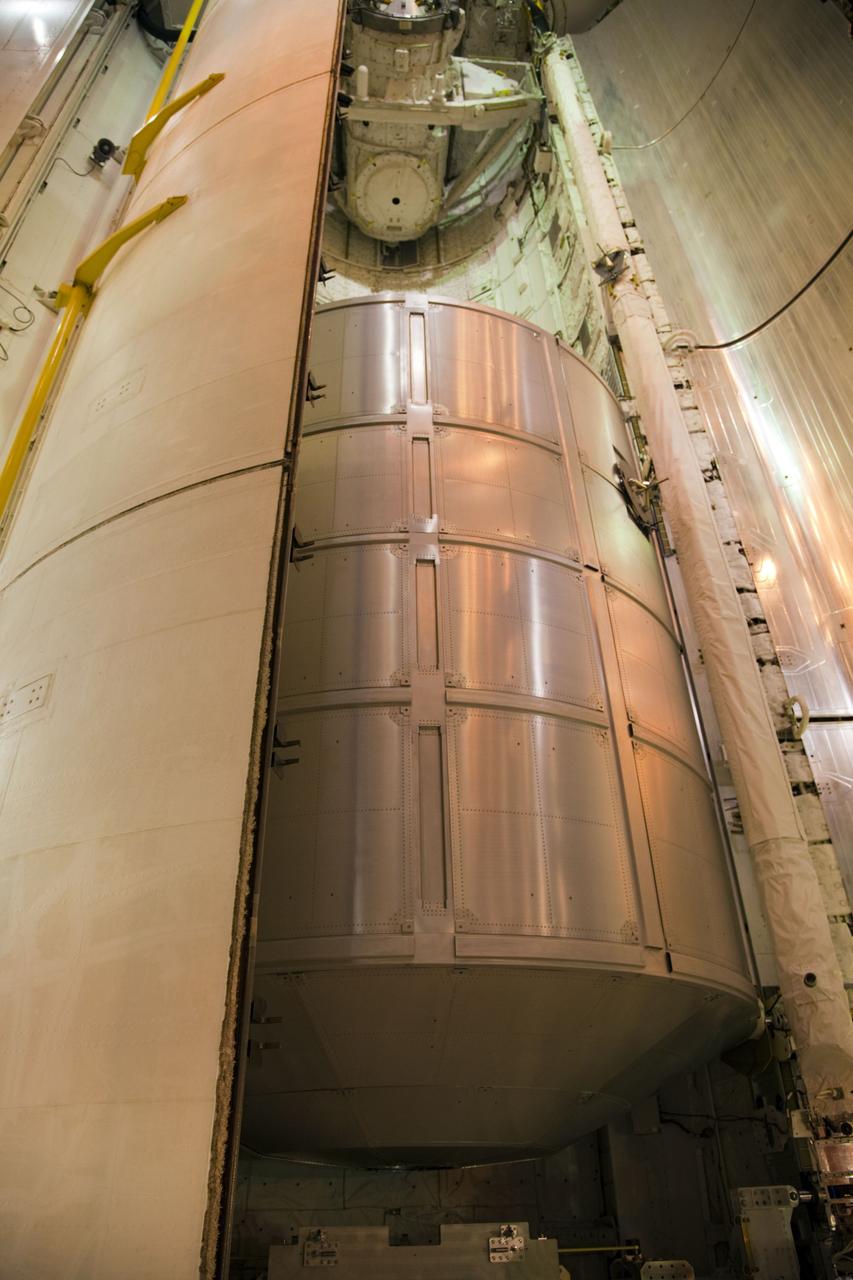 CAPE CANAVERAL, Fla. -- At Launch Pad 39A at NASA's Kennedy Space Center in Florida, space shuttle Atlantis' payload bay doors close around the Raffaello multi-purpose logistics module (MPLM) payload for Atlantis' STS-135 mission to the International Space Station.          Commander Chris Ferguson, Pilot Doug Hurley and Mission Specialists Sandra Magnus and Rex Walheim are slated to lift off on July 8, taking with them the MPLM packed with supplies and spare parts to the station. The STS-135 mission also will fly a system to investigate the potential for robotically refueling existing satellites and return a failed ammonia pump module to help NASA better understand the failure mechanism and improve pump designs for future systems. STS-135 will be the 33rd flight of Atlantis, the 37th shuttle mission to the space station, and the 135th and final mission of NASA's Space Shuttle Program. For more information visit, www.nasa.gov/mission_pages/shuttle/shuttlemissions/sts135/index.html. Photo credit: NASA/Frank Michaux